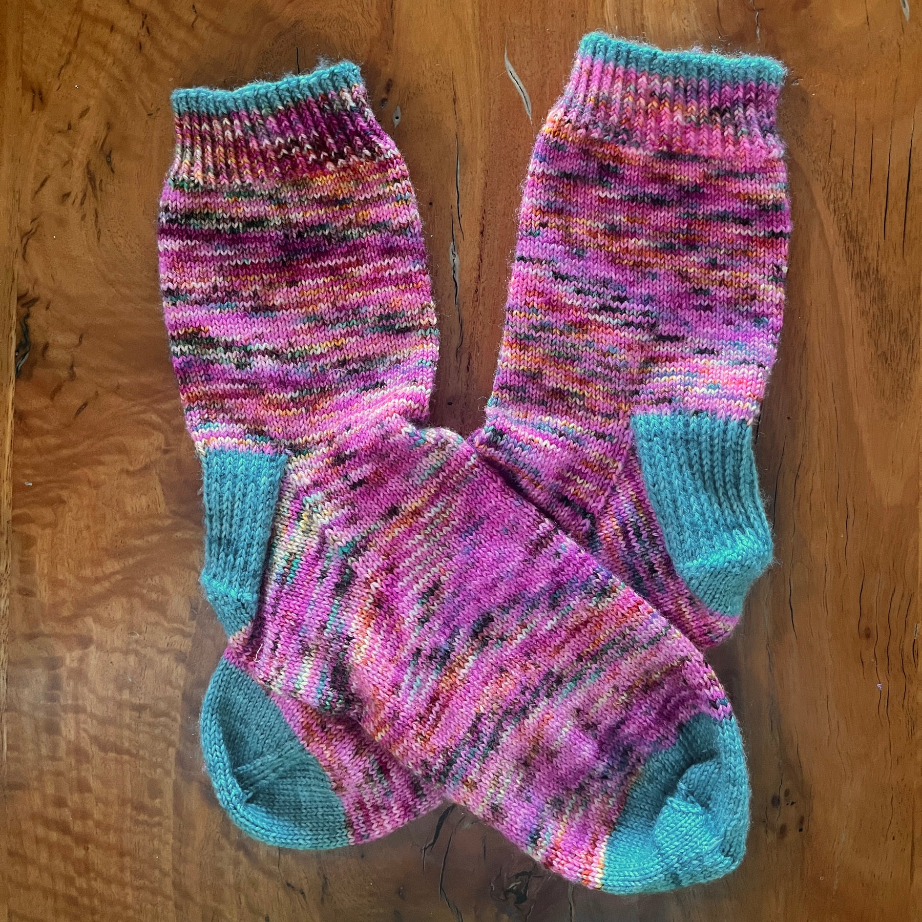 Hand knit socks using Australian hand dyed yarn - pink with teal highlights