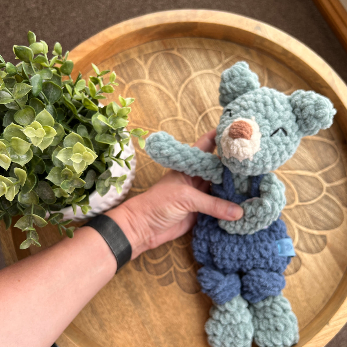 Handmade crochet Mini Teddy in overalls modern lovey with knotted legs.