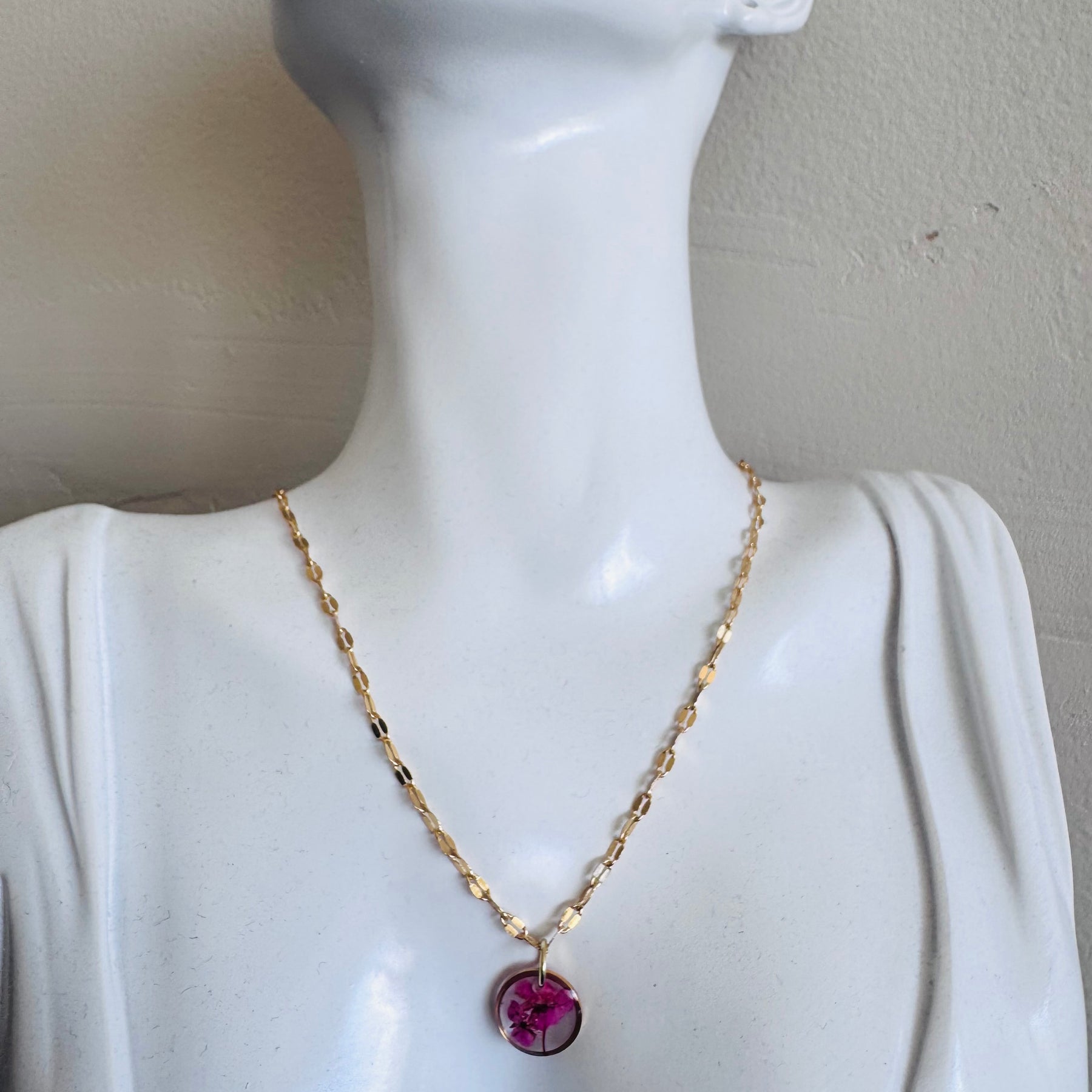 Gold plated resin necklace with fuchsia pink wildflower