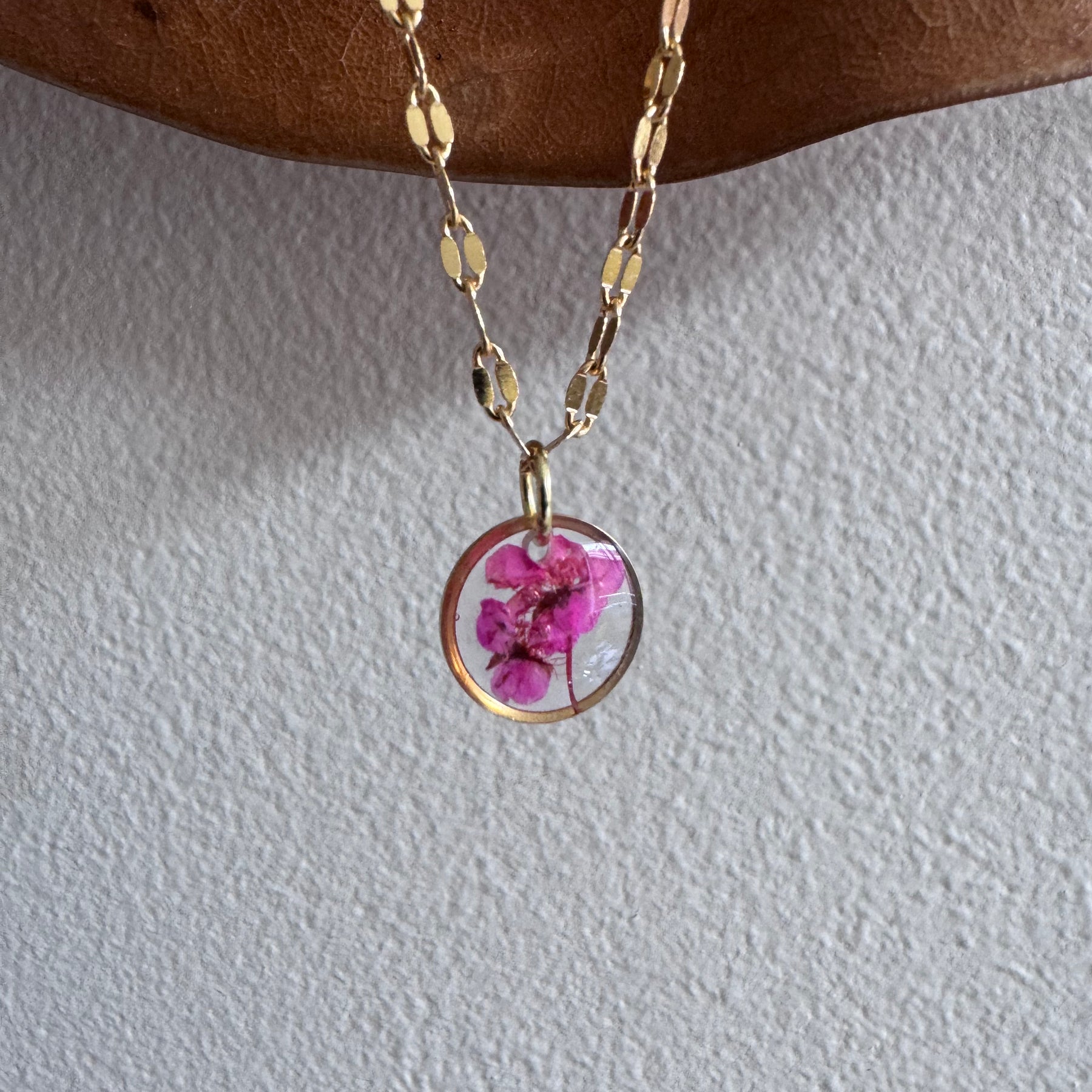 Gold plated resin necklace with fuchsia pink wildflower