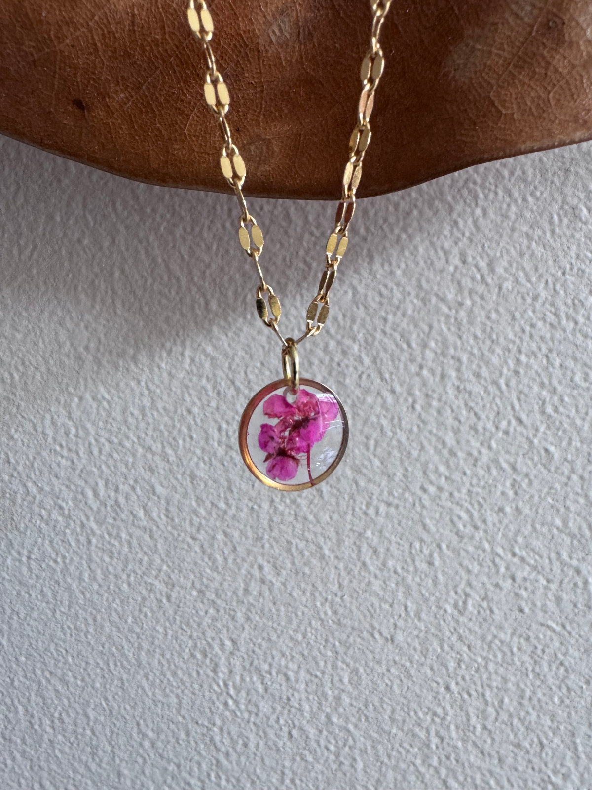 Gold plated resin necklace with fuchsia pink wildflower