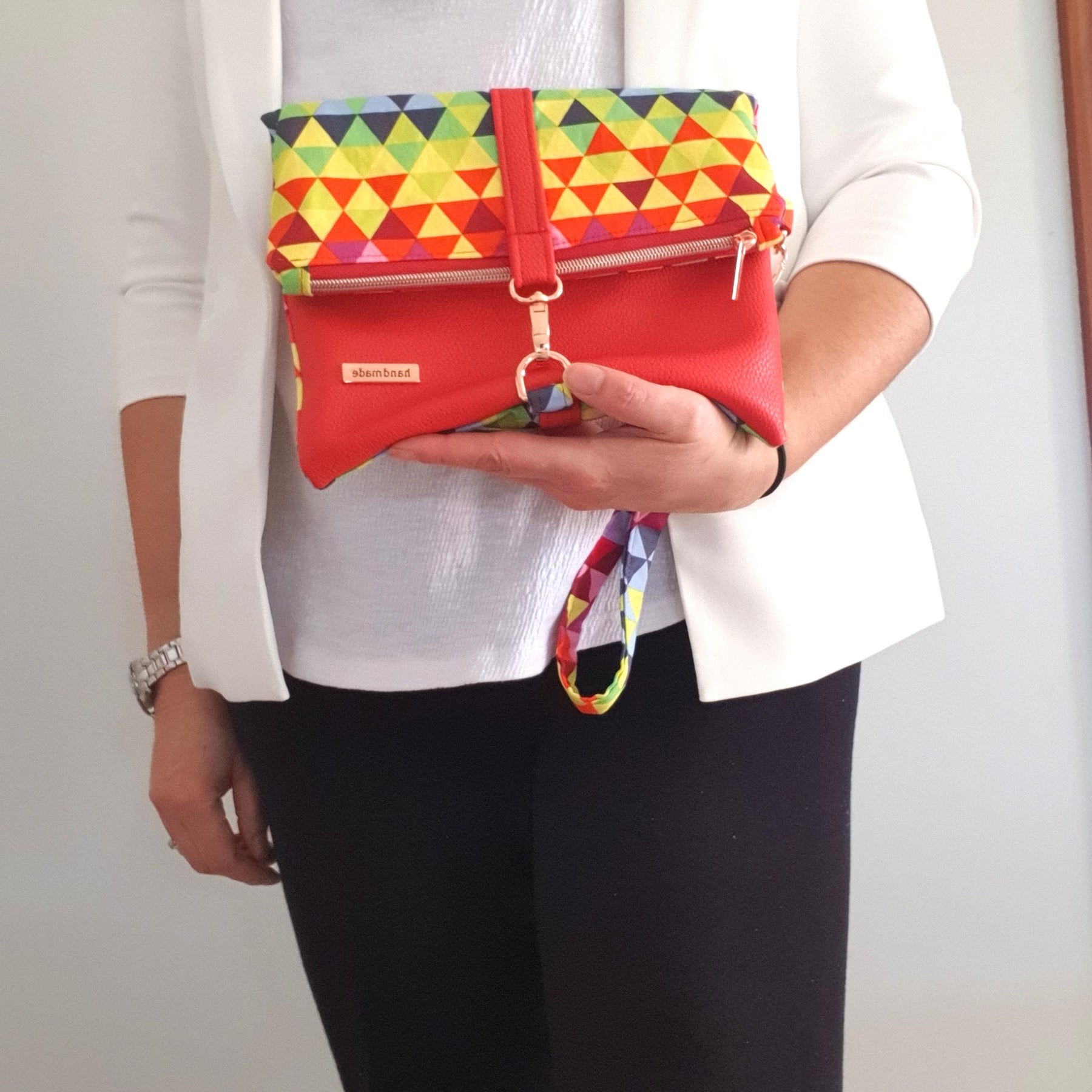 Multi colored red modern fold over zipper clutch with detachable strap