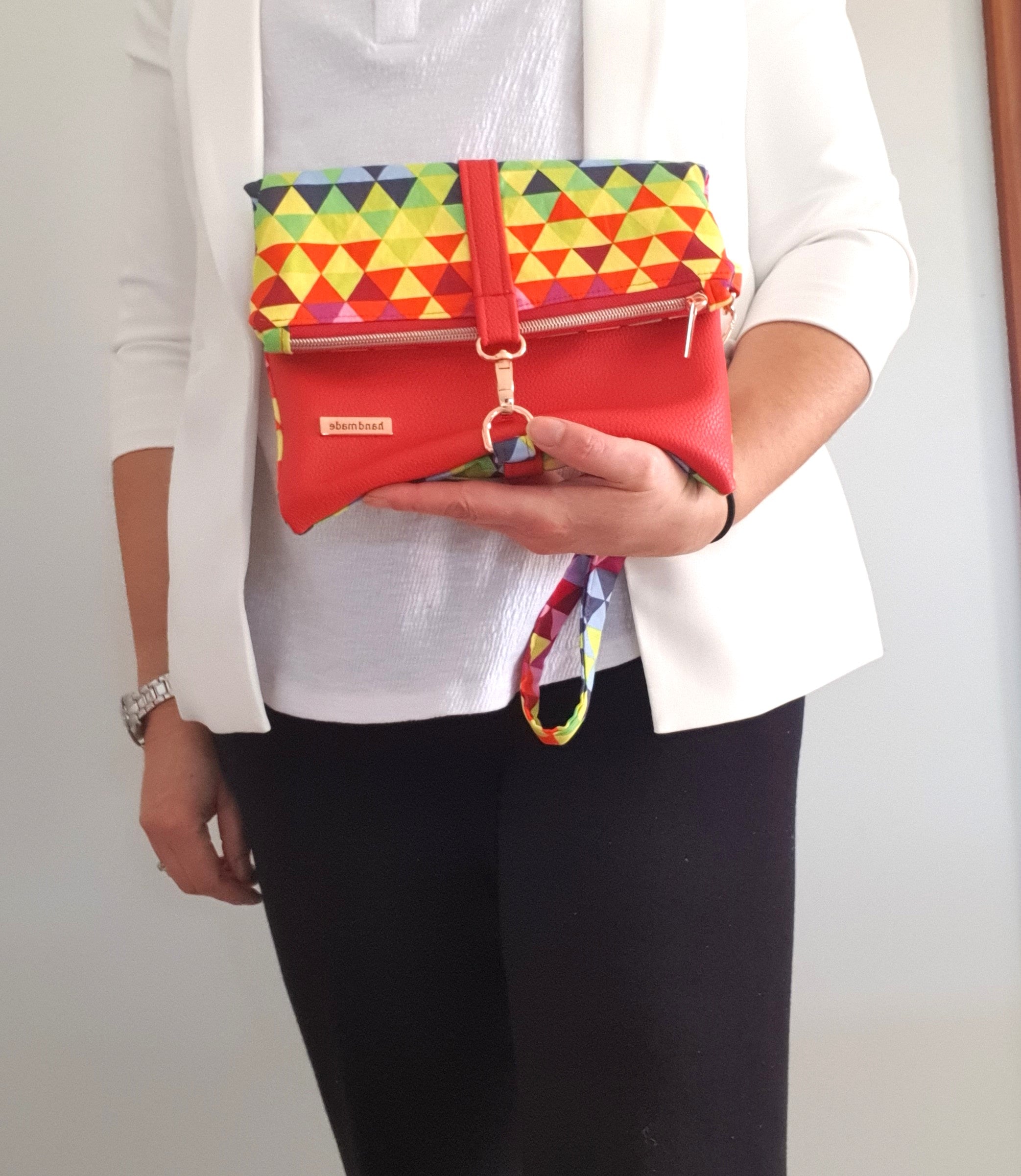 Multi colored red modern fold over zipper clutch with detachable strap