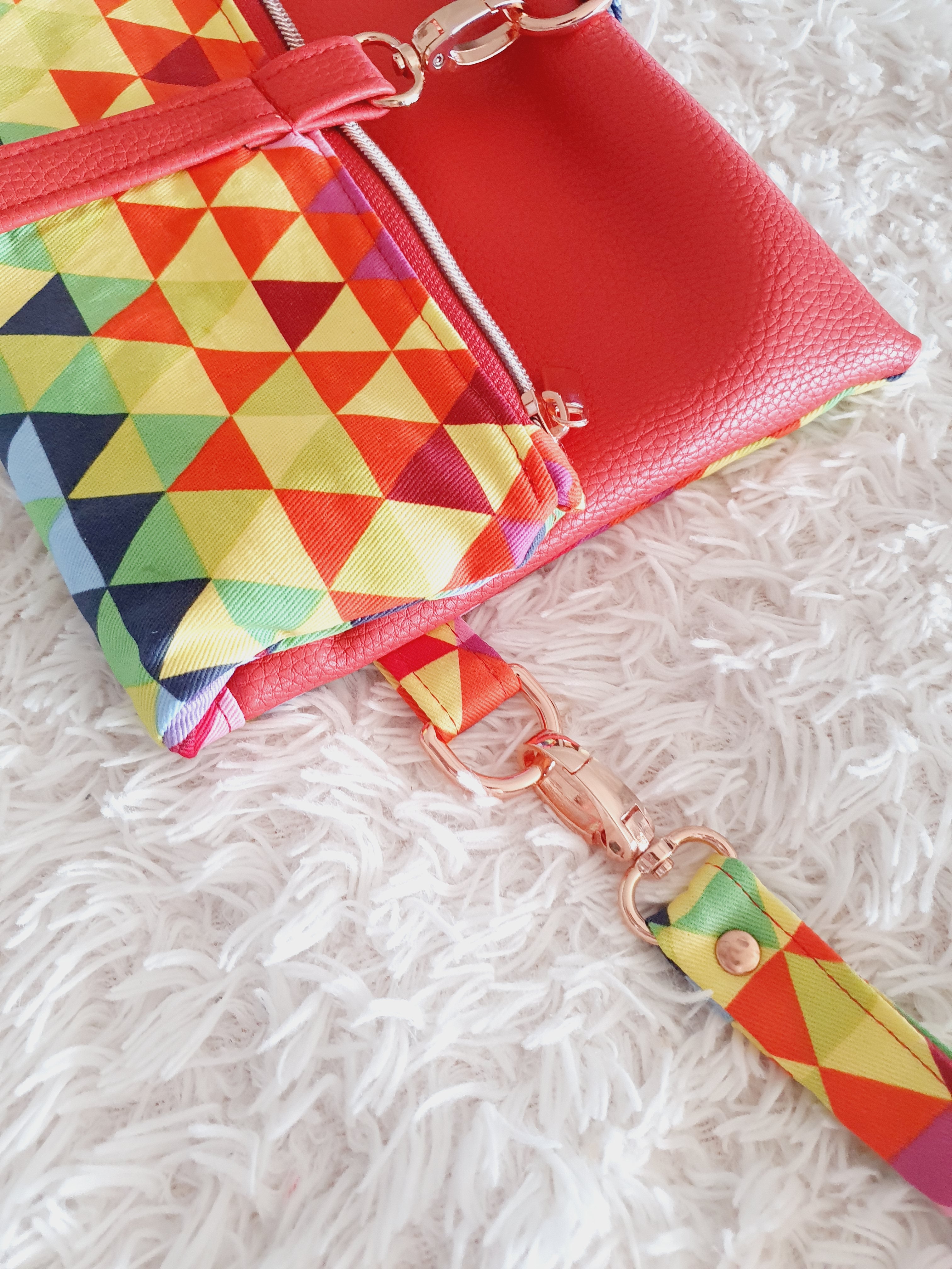Multi colored red modern fold over zipper clutch with detachable strap