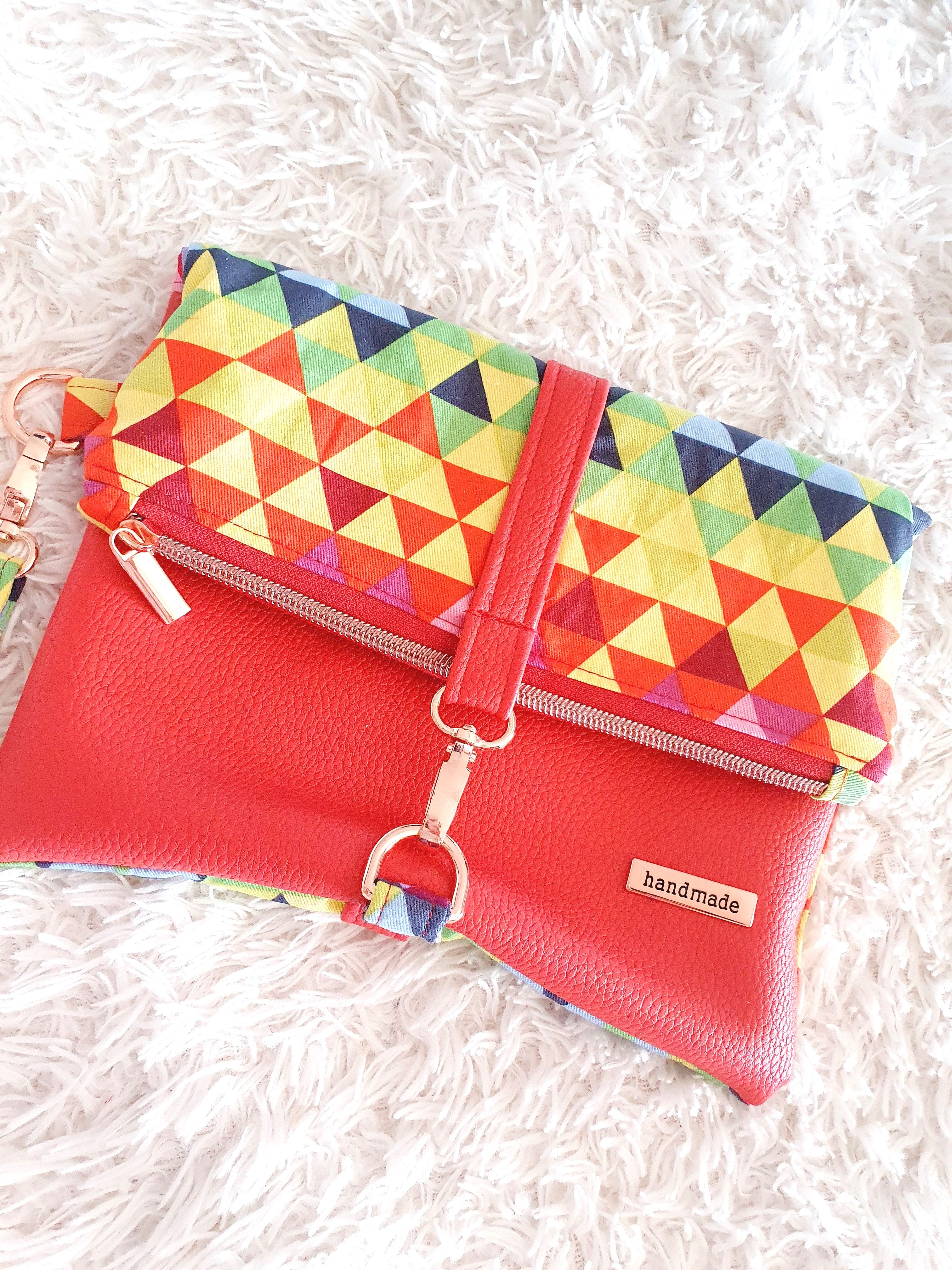 Multi colored red modern fold over zipper clutch with detachable strap