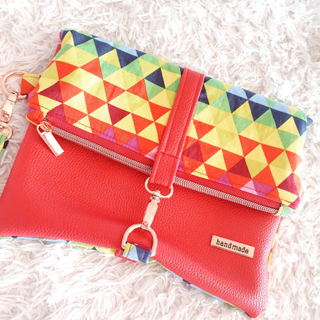 Multi colored red modern fold over zipper clutch with detachable strap