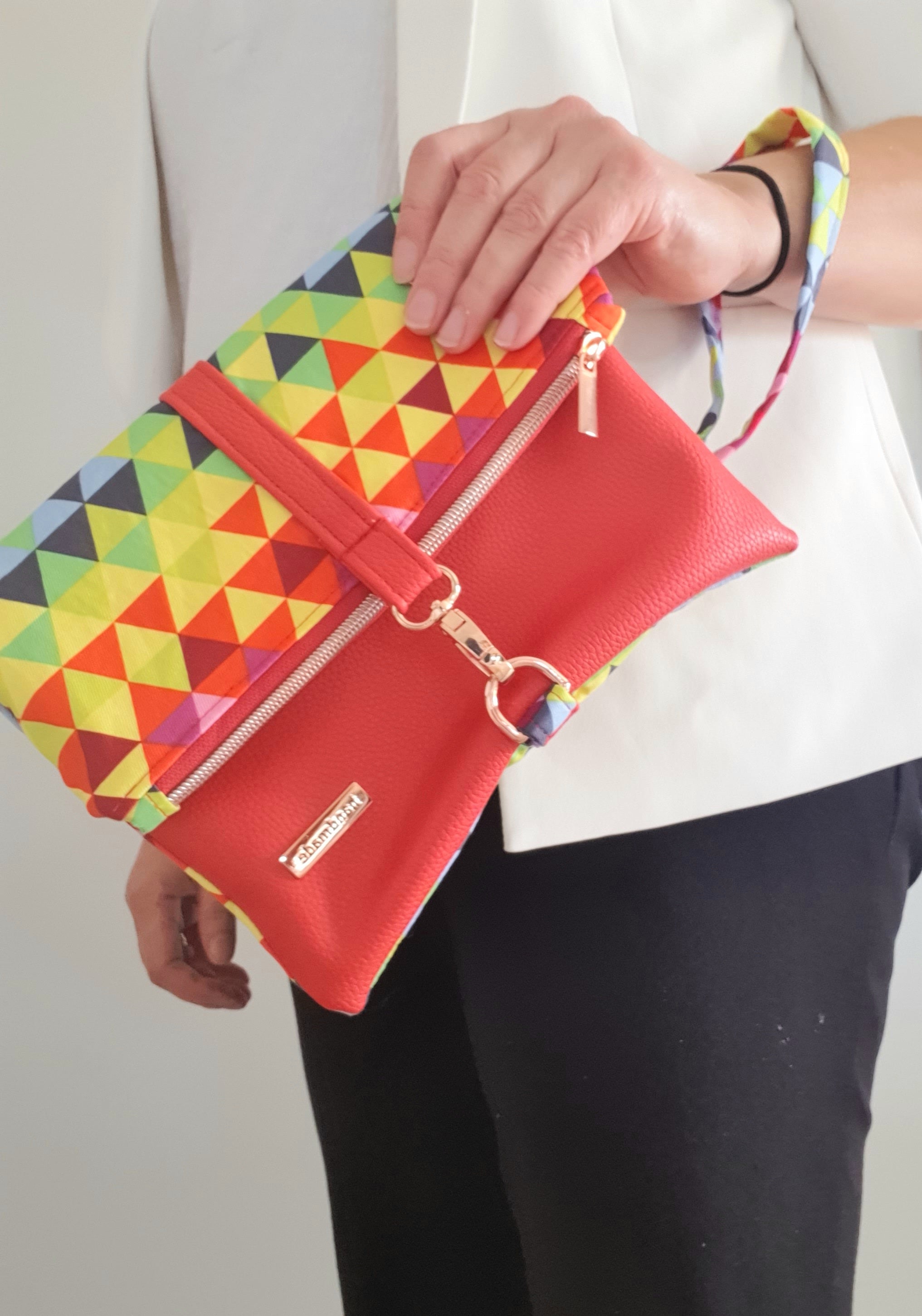 Multi colored red modern fold over zipper clutch with detachable strap