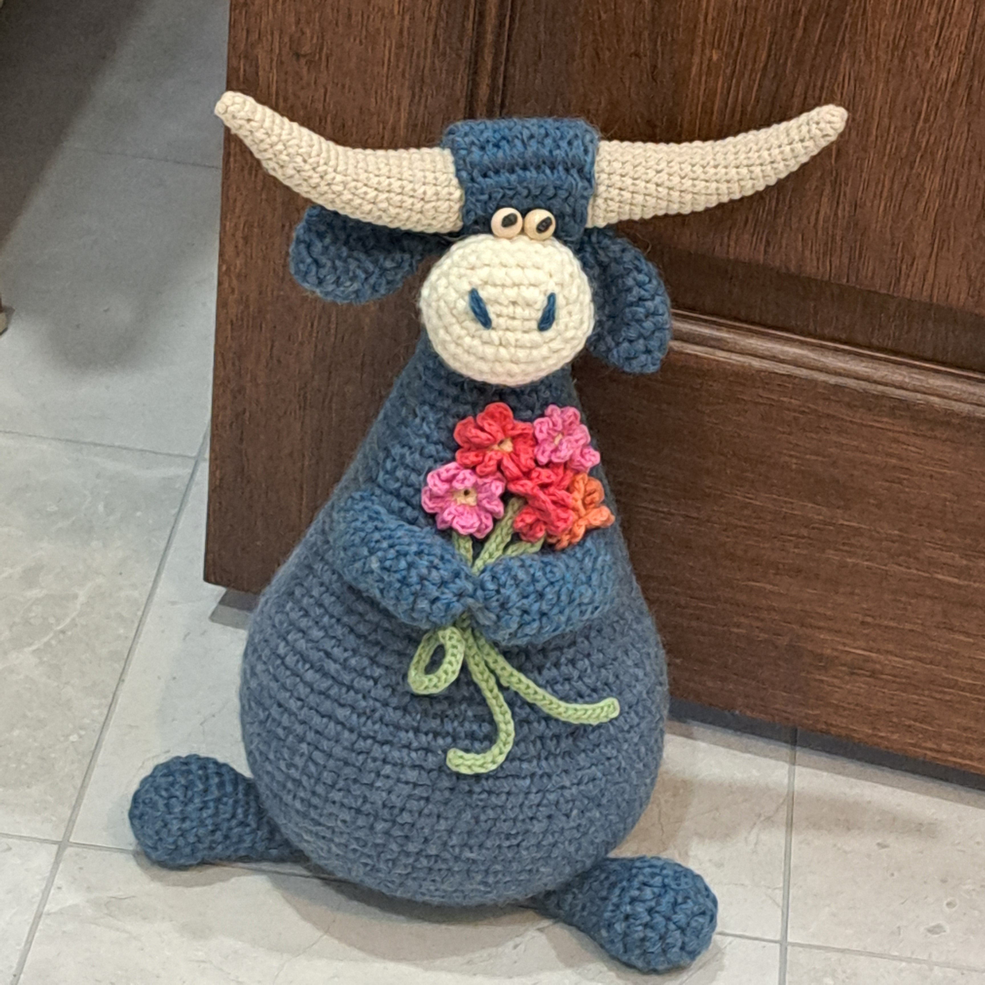 Handmade Highland cow crochet character doorstop in blue