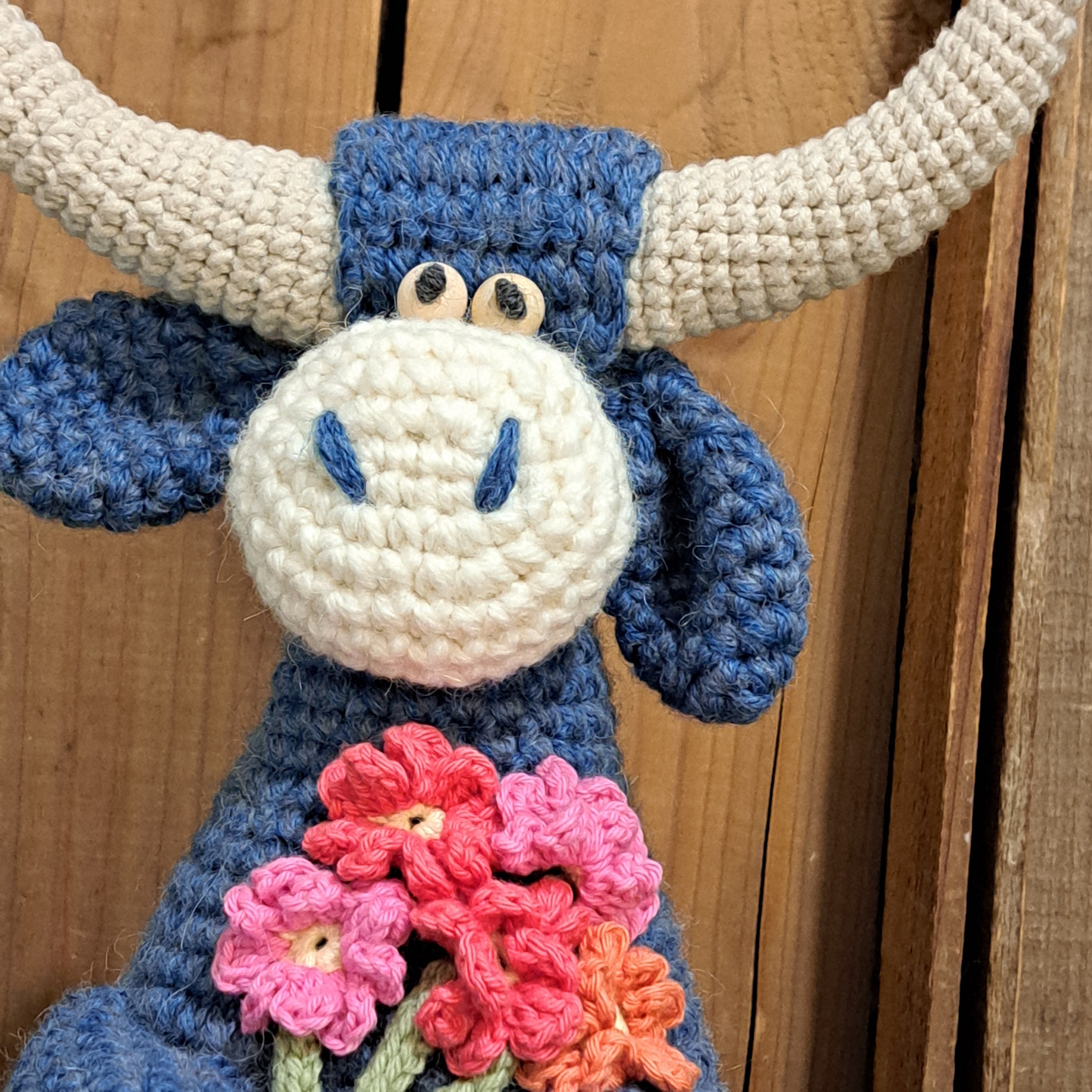 Handmade Highland cow crochet character doorstop in blue