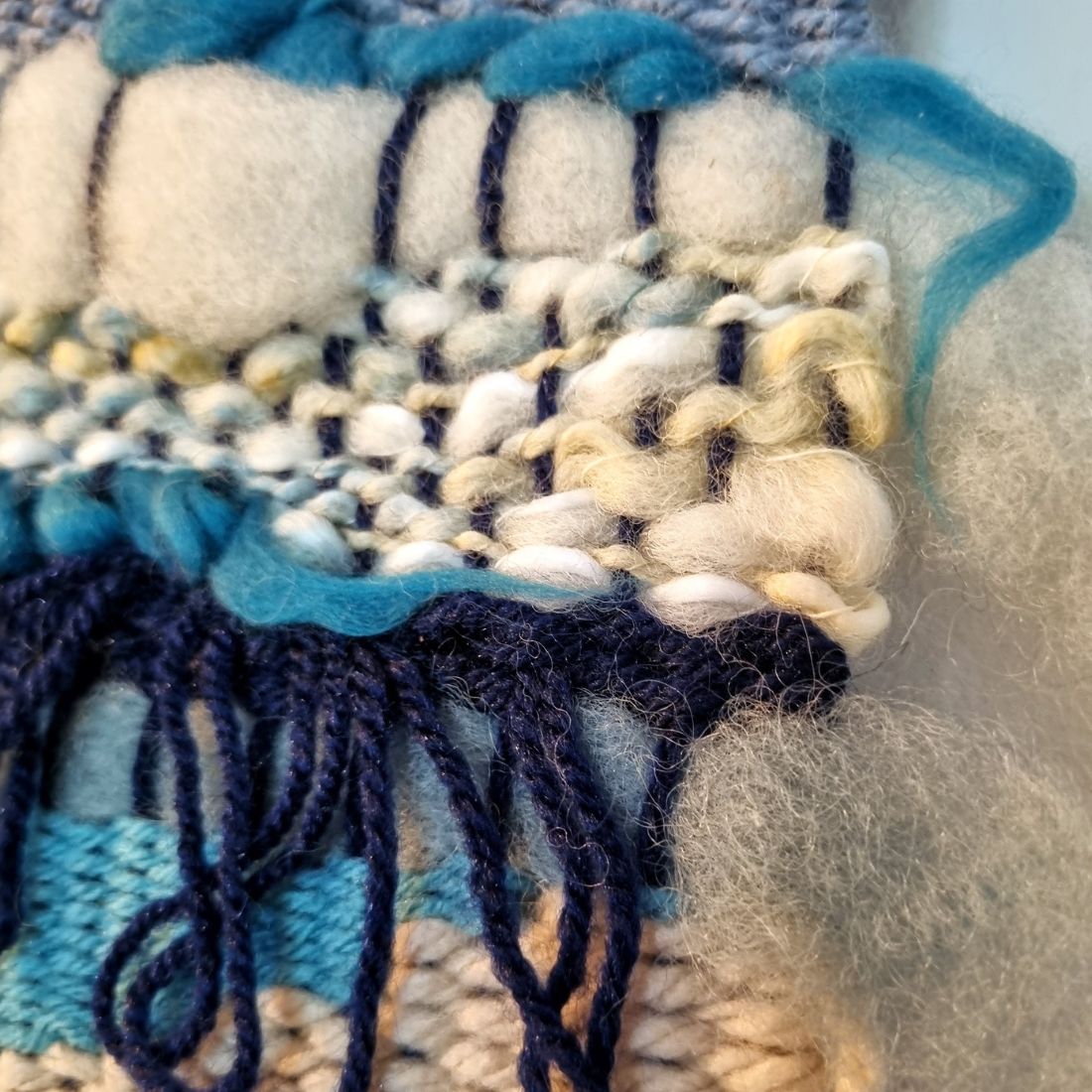 Handwoven wall hanging in blue and cream