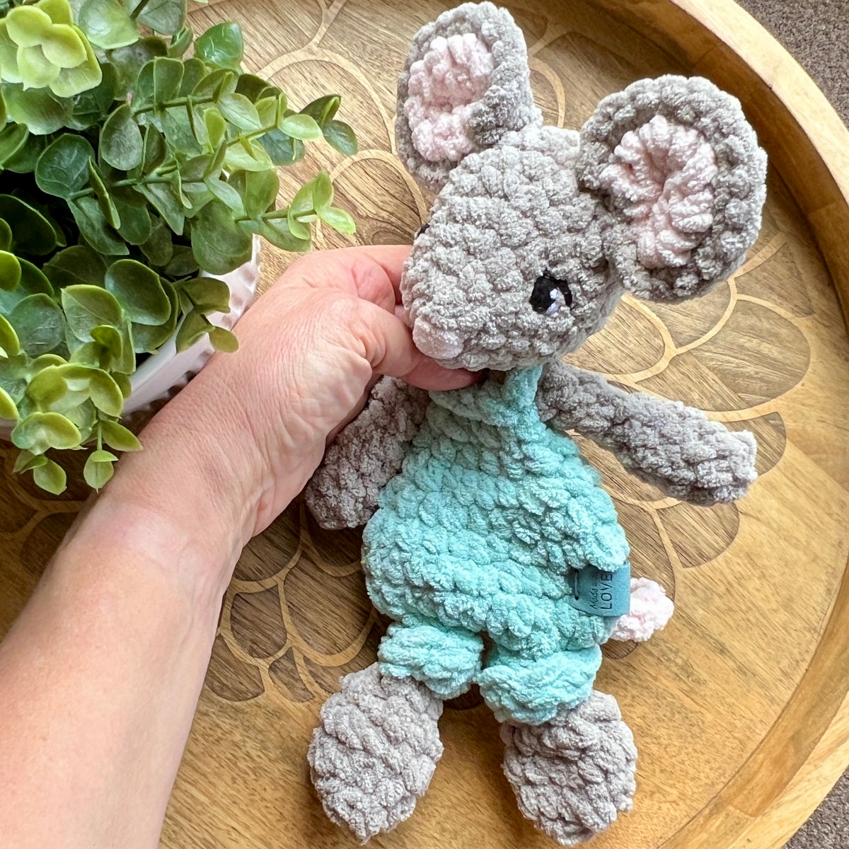 Handmade crochet Mini Mouse modern lovey in overalls with knotted legs.