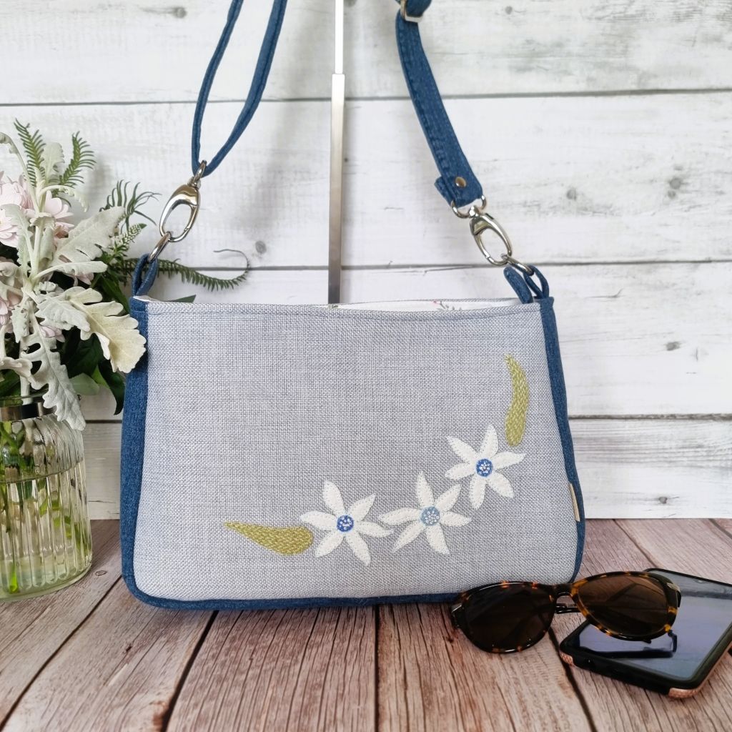 Handmade appliqued crossbody zip bag - blue with flannel flowers