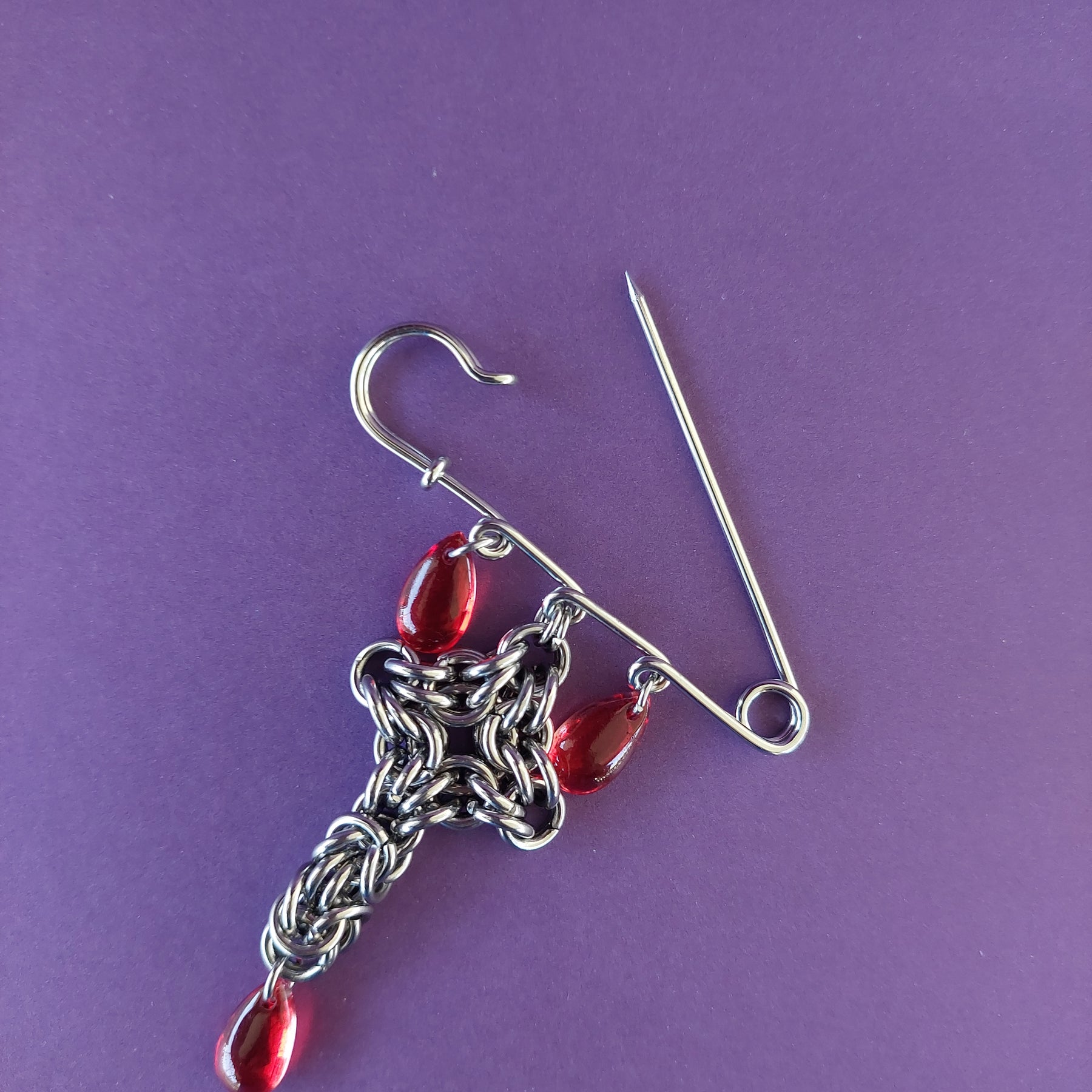 Bleeding cross brooch