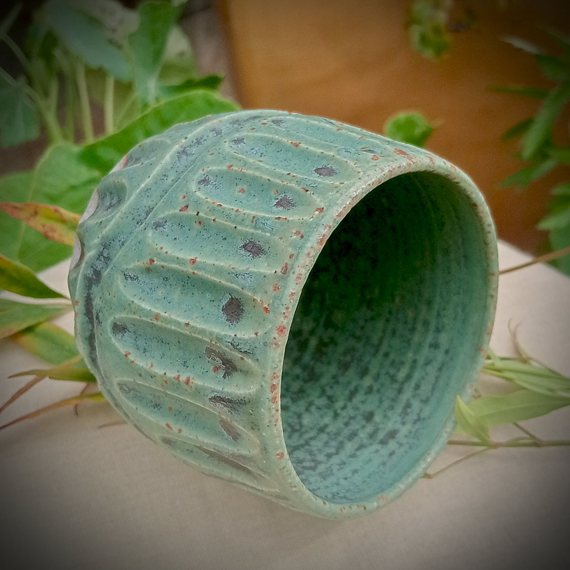 Rustic green and black coffee tumbler with rusty coloured flecks