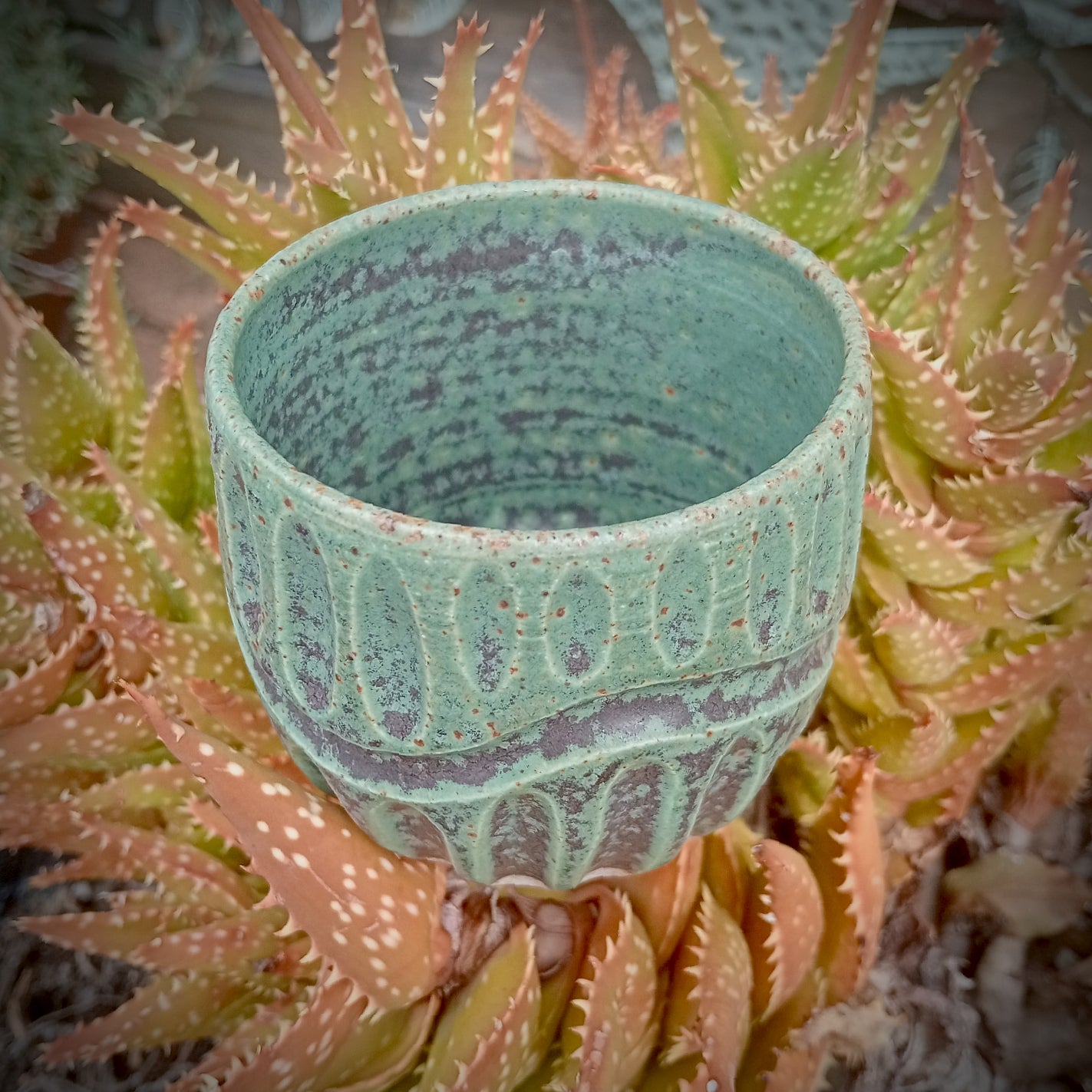 Rustic green and black coffee tumbler with rusty coloured flecks