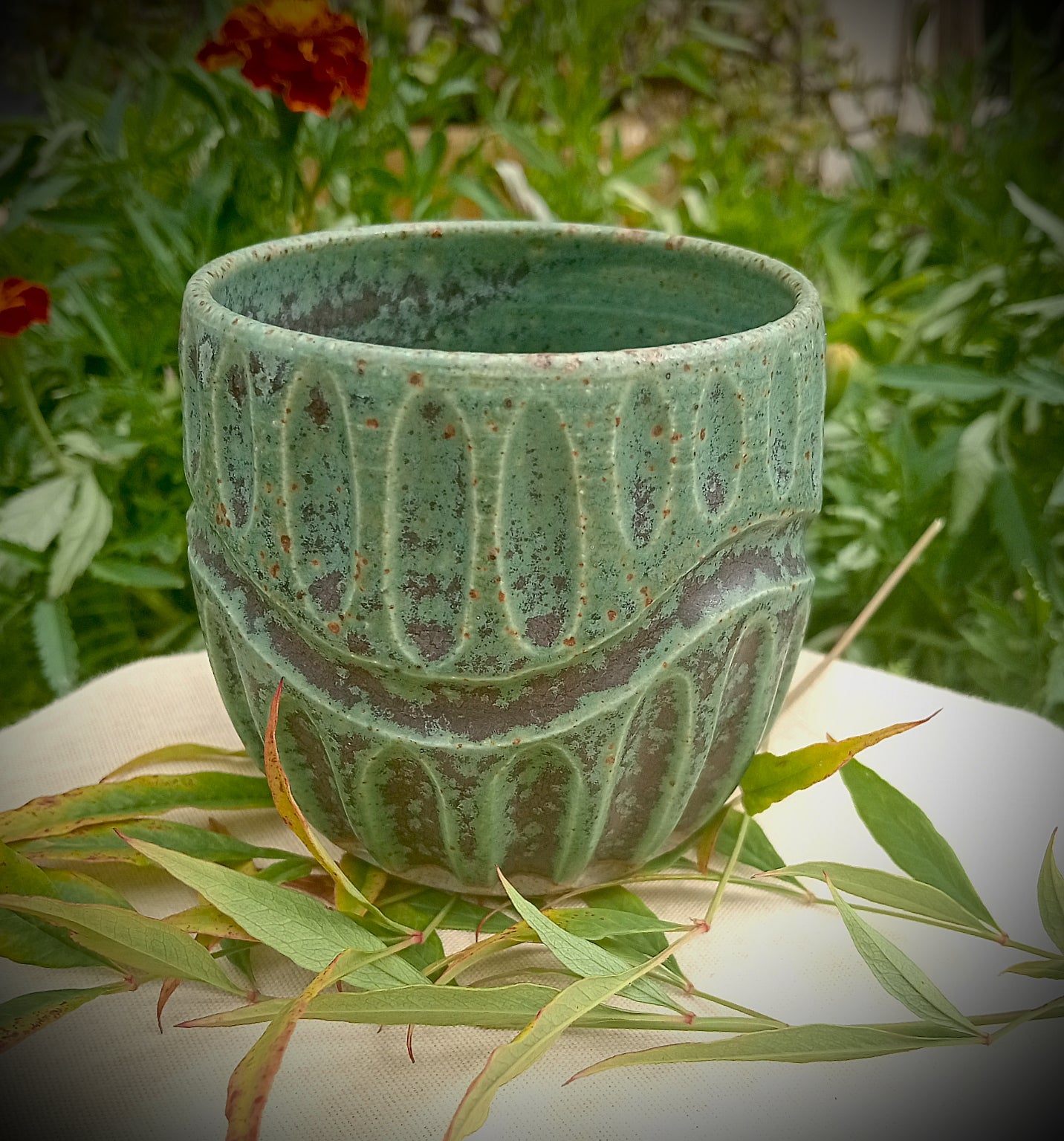 Rustic green and black coffee tumbler with rusty coloured flecks