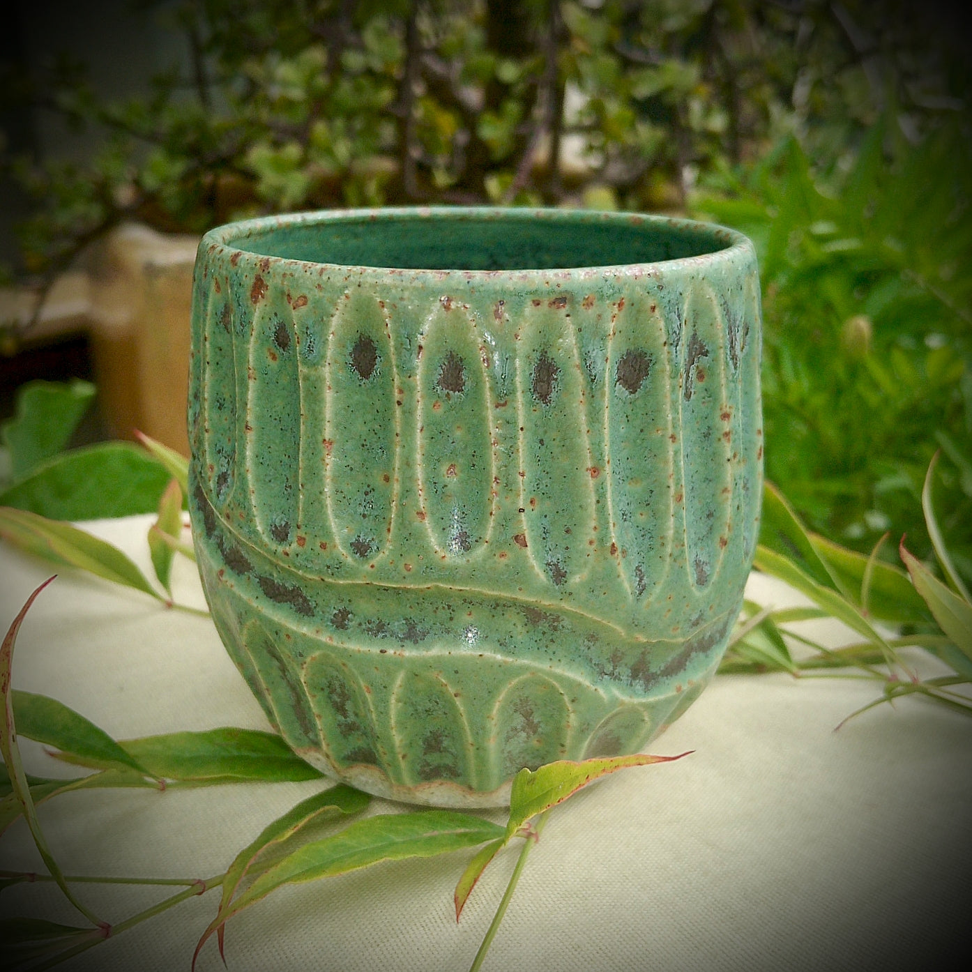 Rustic green and black coffee tumbler with rusty coloured flecks