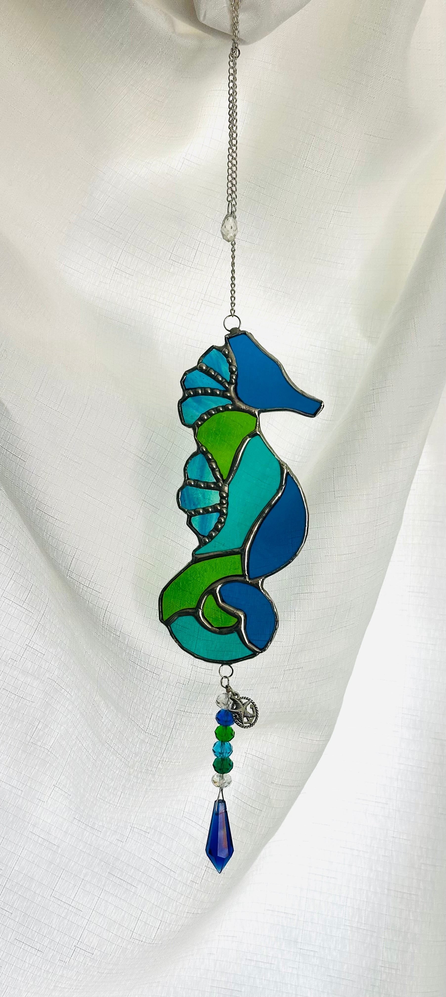 Stained glass seahorse in blue and green