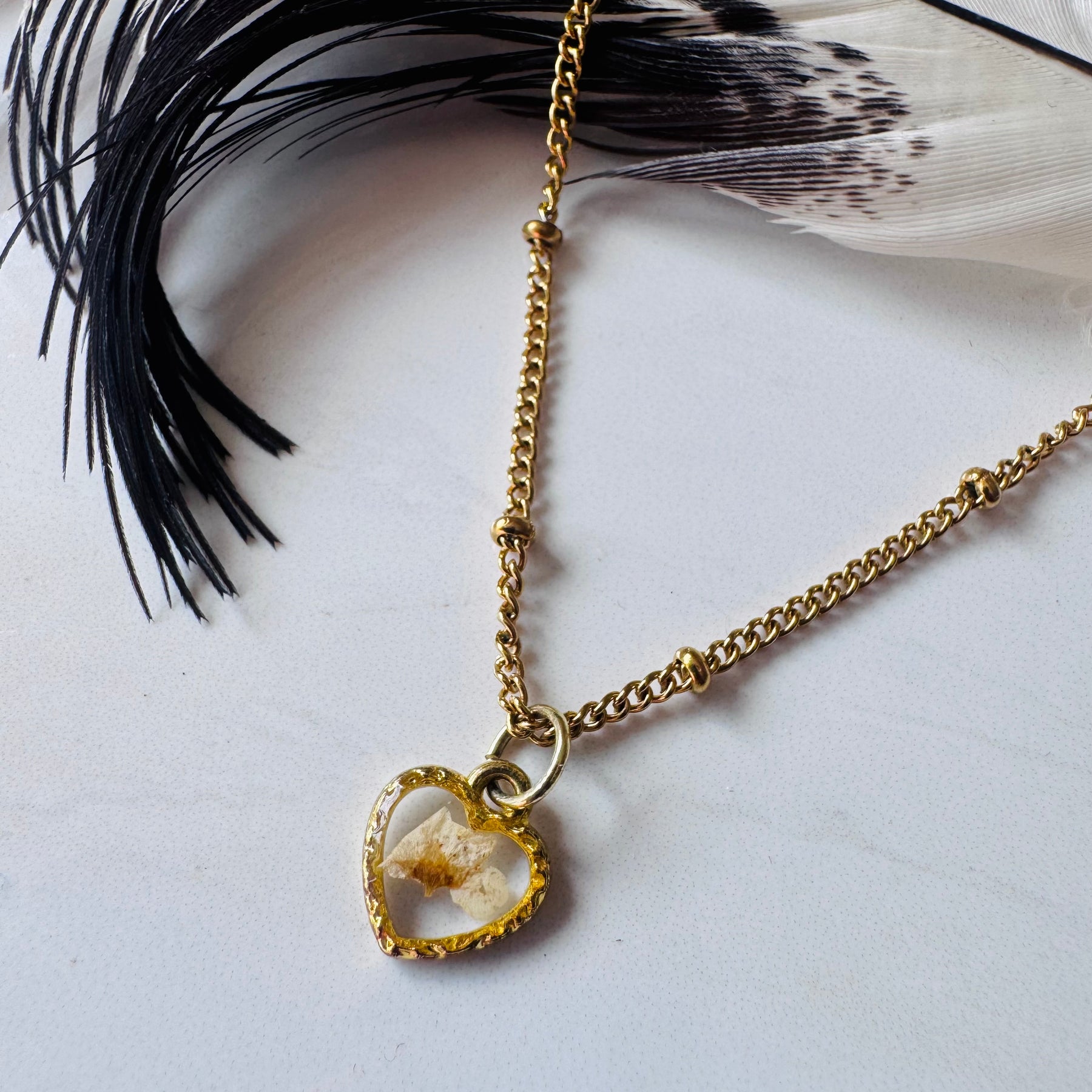 Gold plated resin necklace with white wildflower