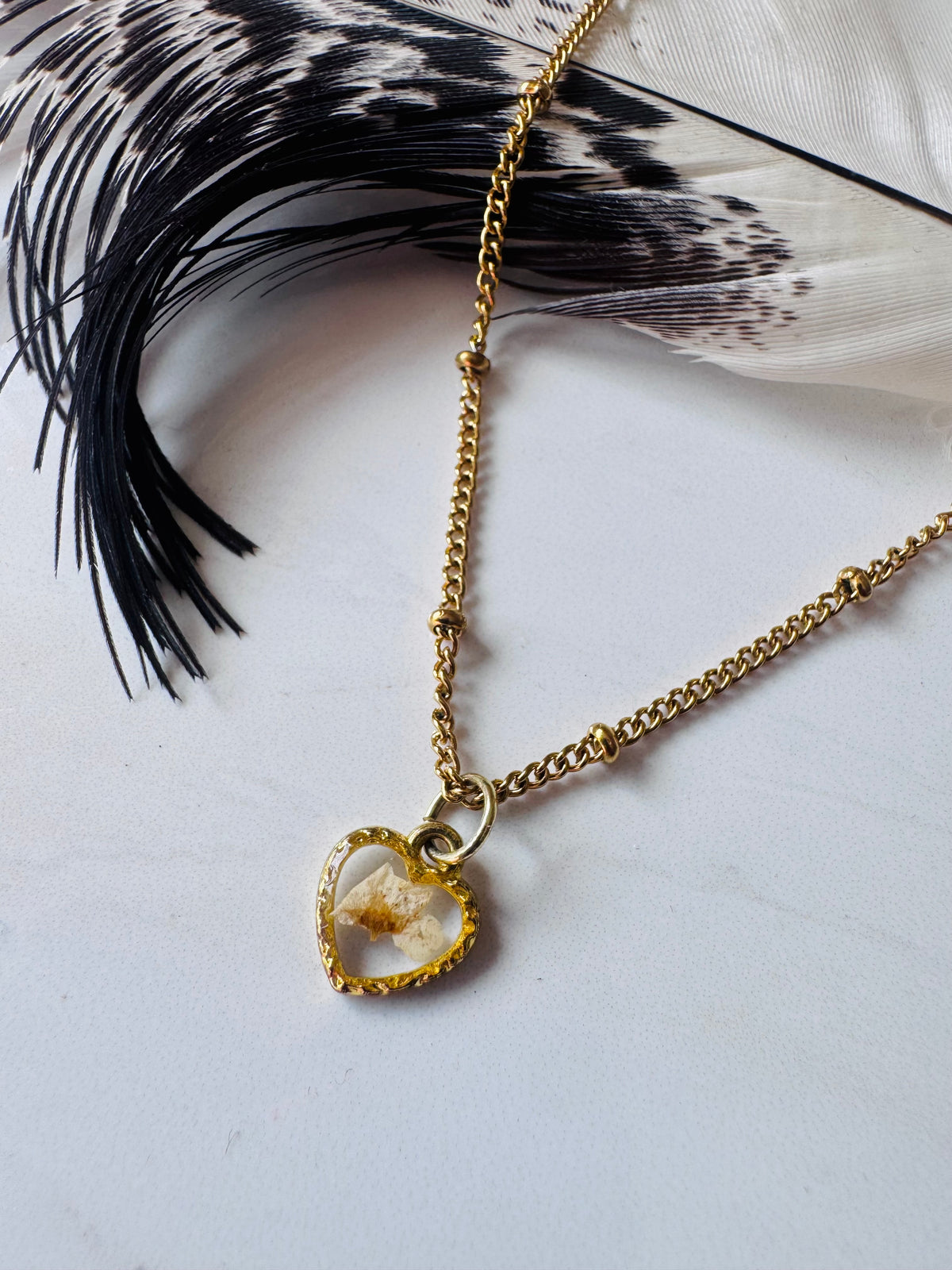 Gold plated resin necklace with white wildflower