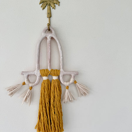 Clay and cord wall hanging