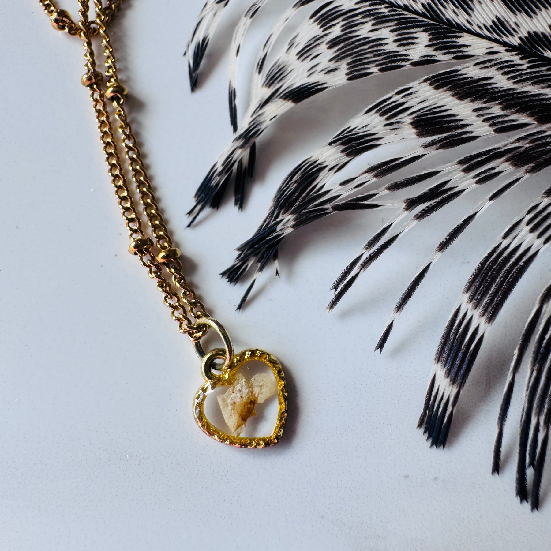 Gold plated resin necklace with white wildflower