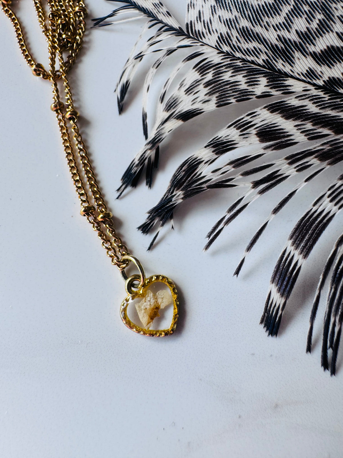 Gold plated resin necklace with white wildflower