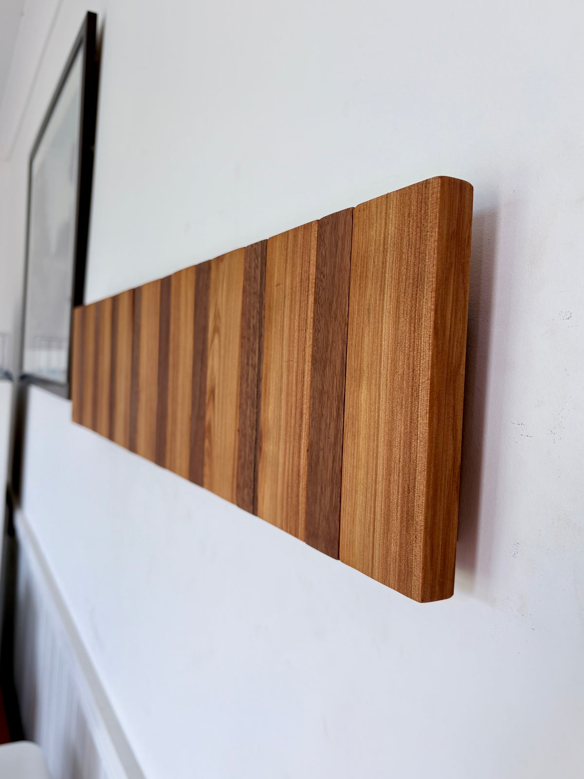 Two tone spotted gum and cypress horizon line piano style coatrack