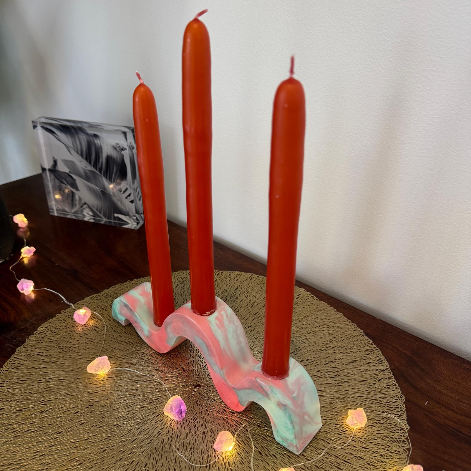 Red and green and gold wavy concrete holder for taper candles