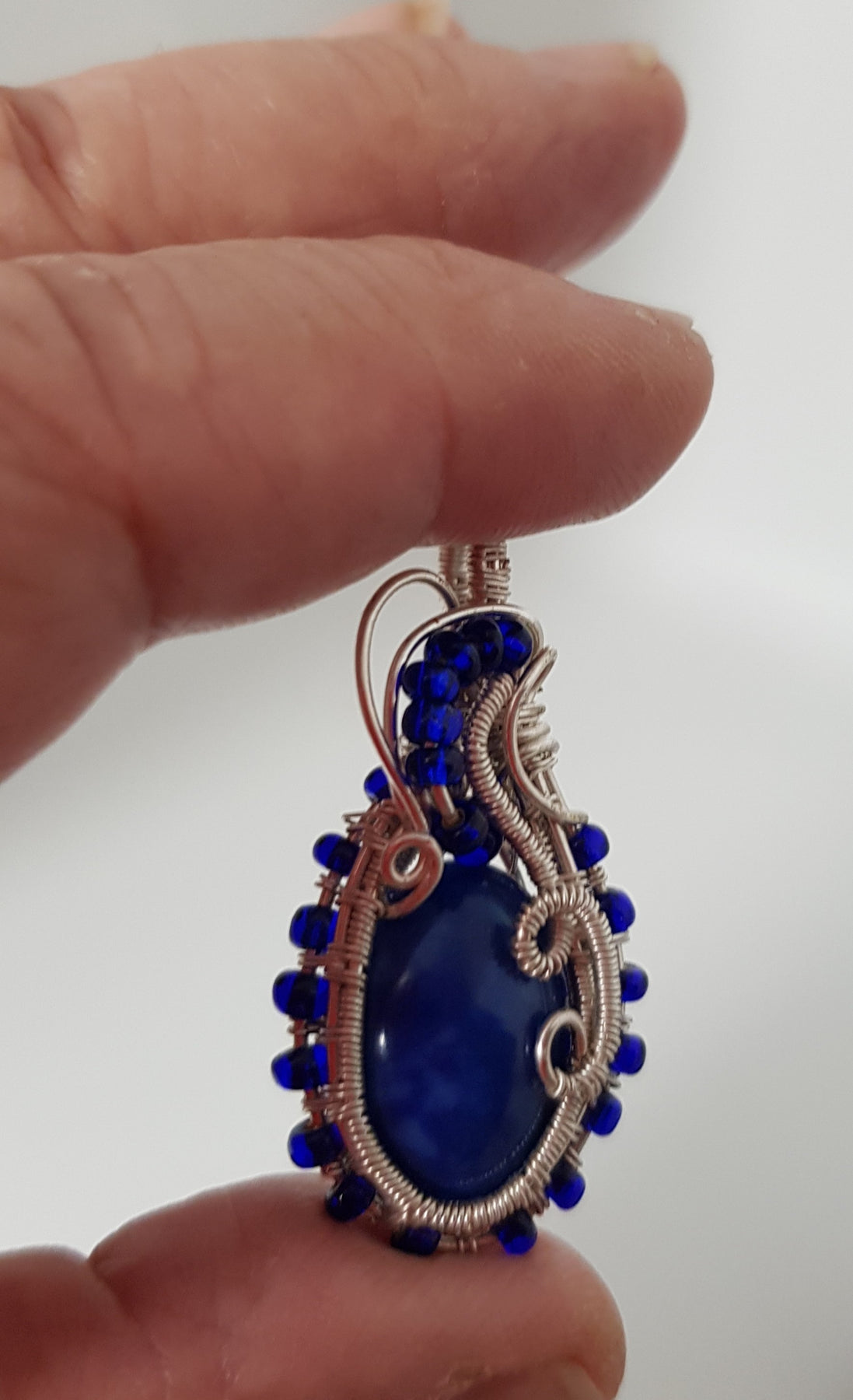small Blue cabachon wire wrapped with silver wire
