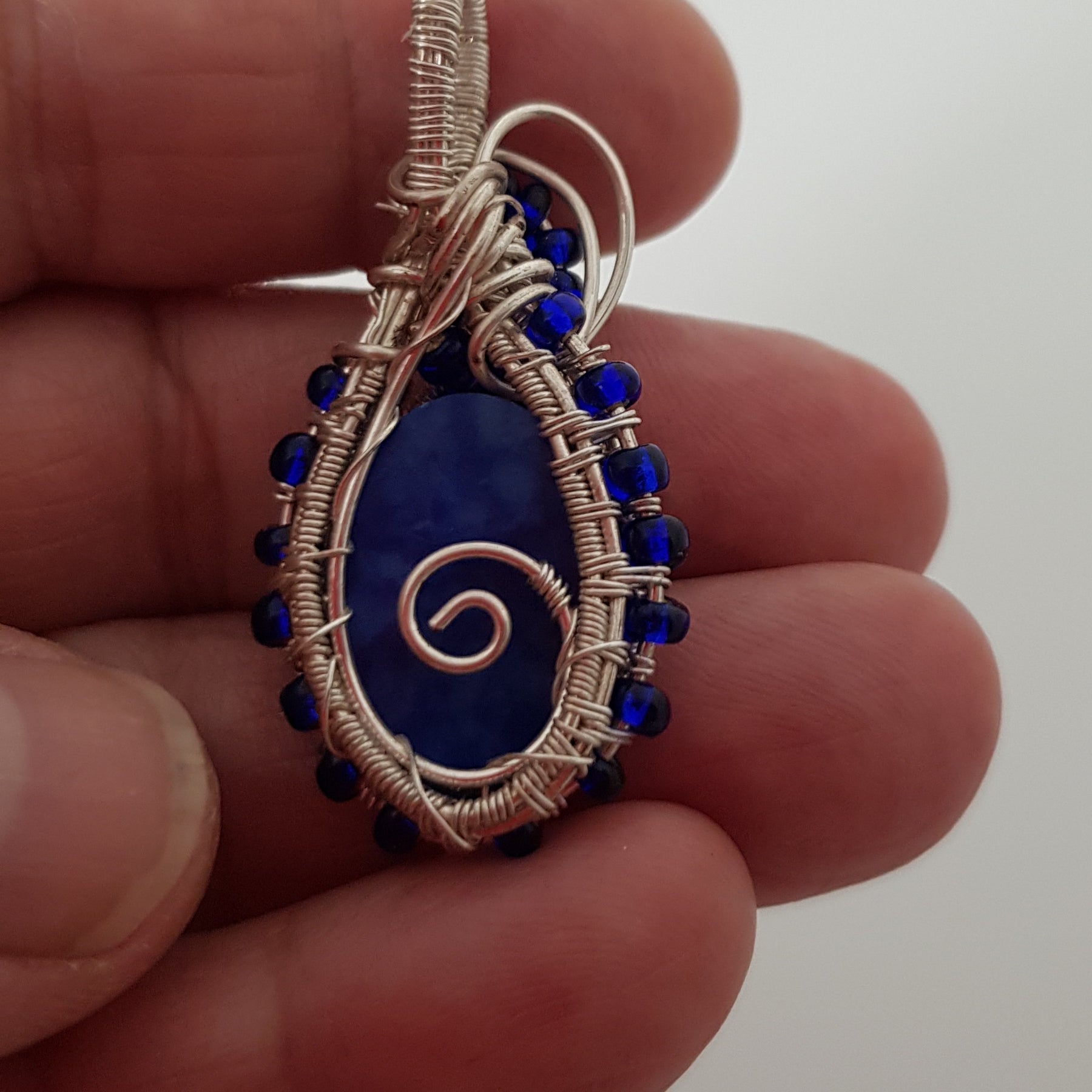 small Blue cabachon wire wrapped with silver wire