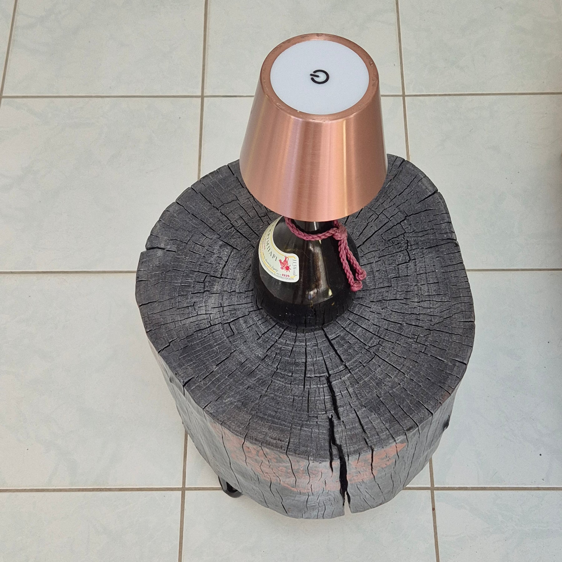 Burnt timber stump tables featuring hand-painted artwork