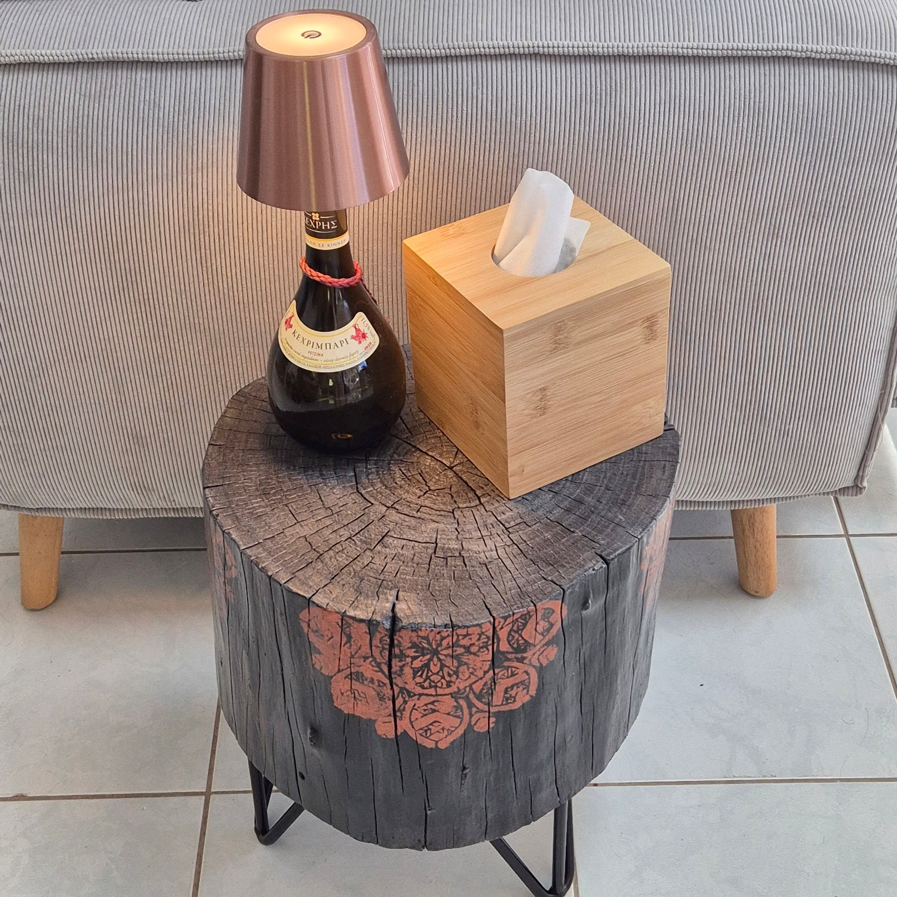 Burnt timber stump tables featuring hand-painted artwork