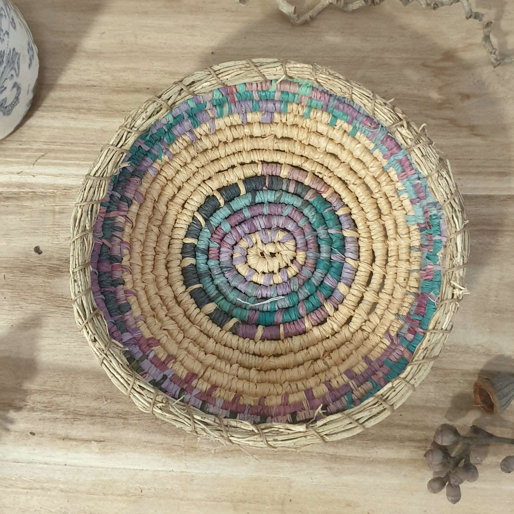 Handmade, raffia and sand vine coil basket,