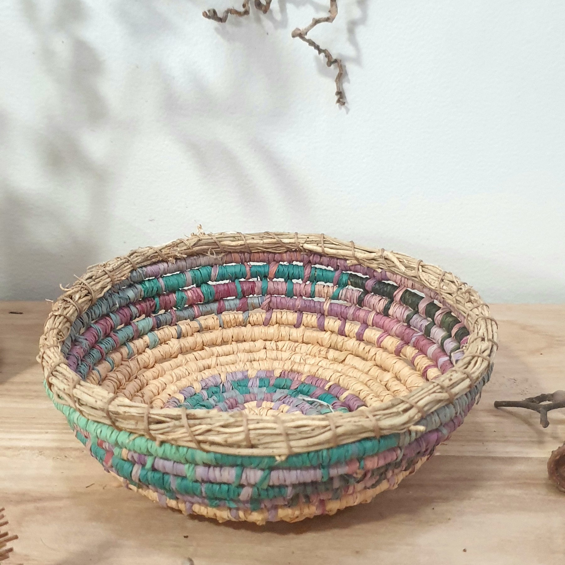 Handmade, raffia and sand vine coil basket,
