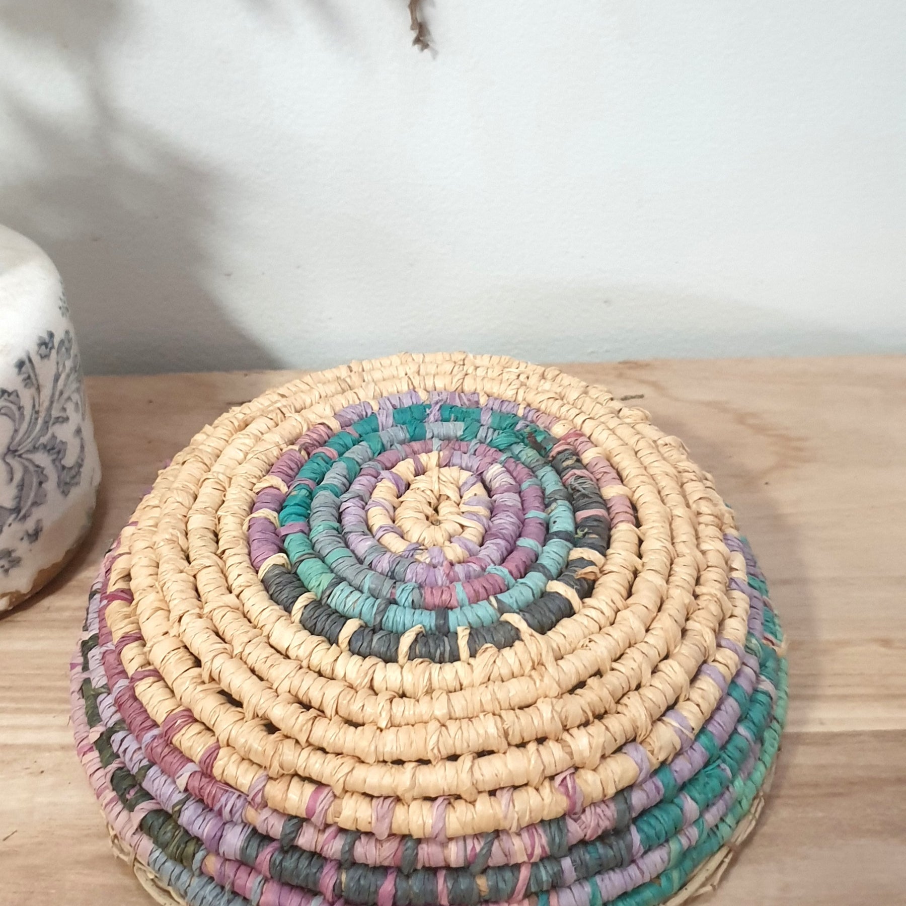 Handmade, raffia and sand vine coil basket,