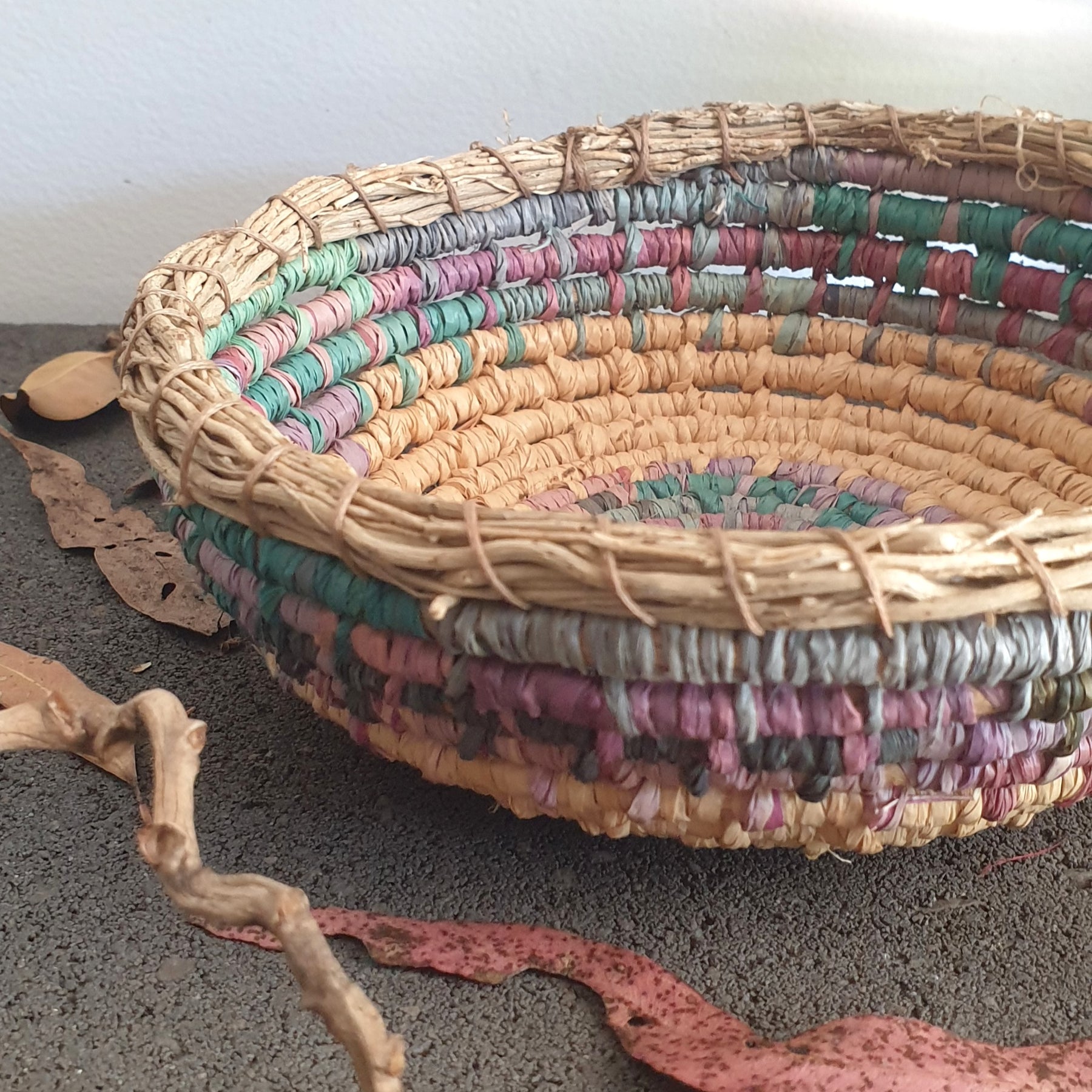 Handmade, raffia and sand vine coil basket,