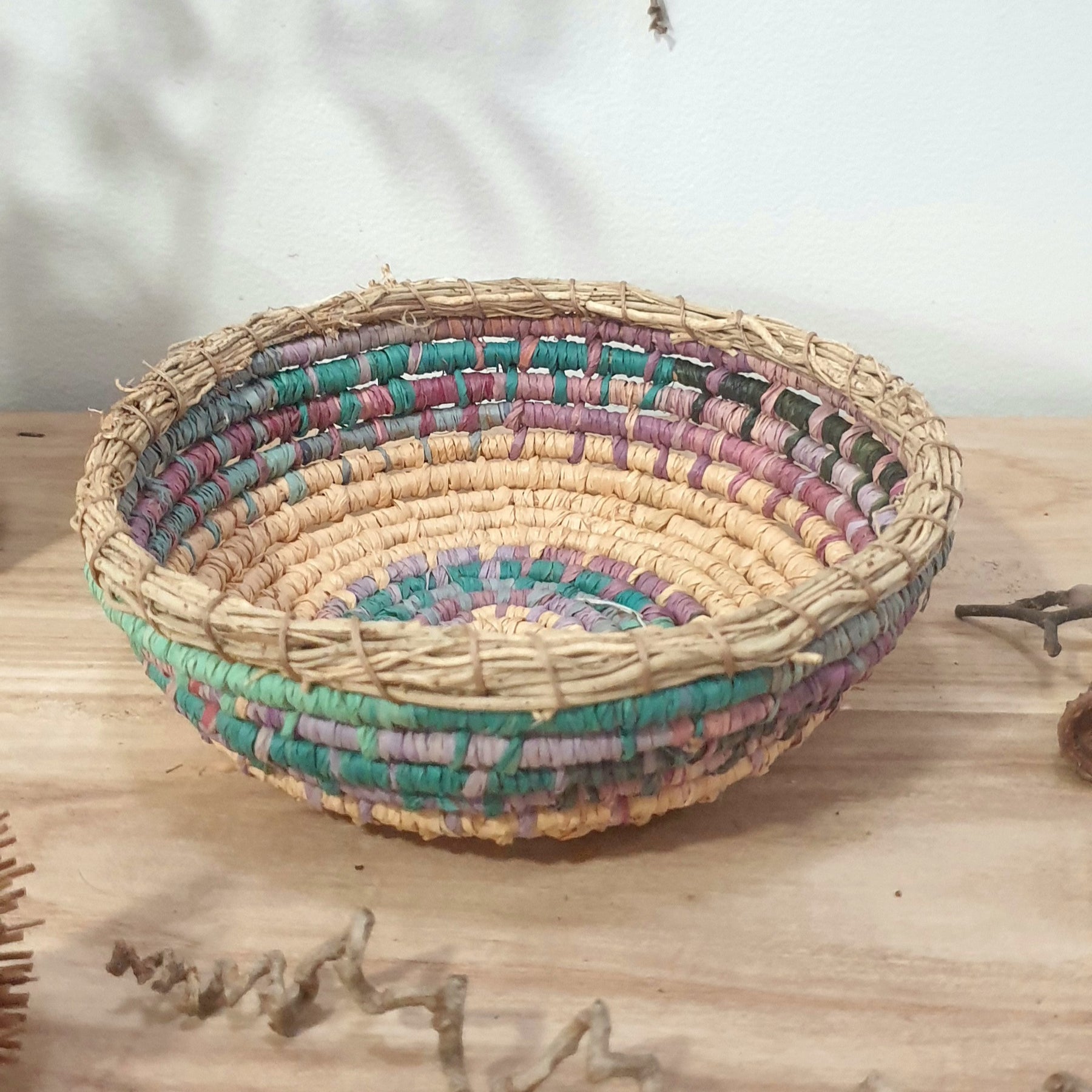 Handmade, raffia and sand vine coil basket,