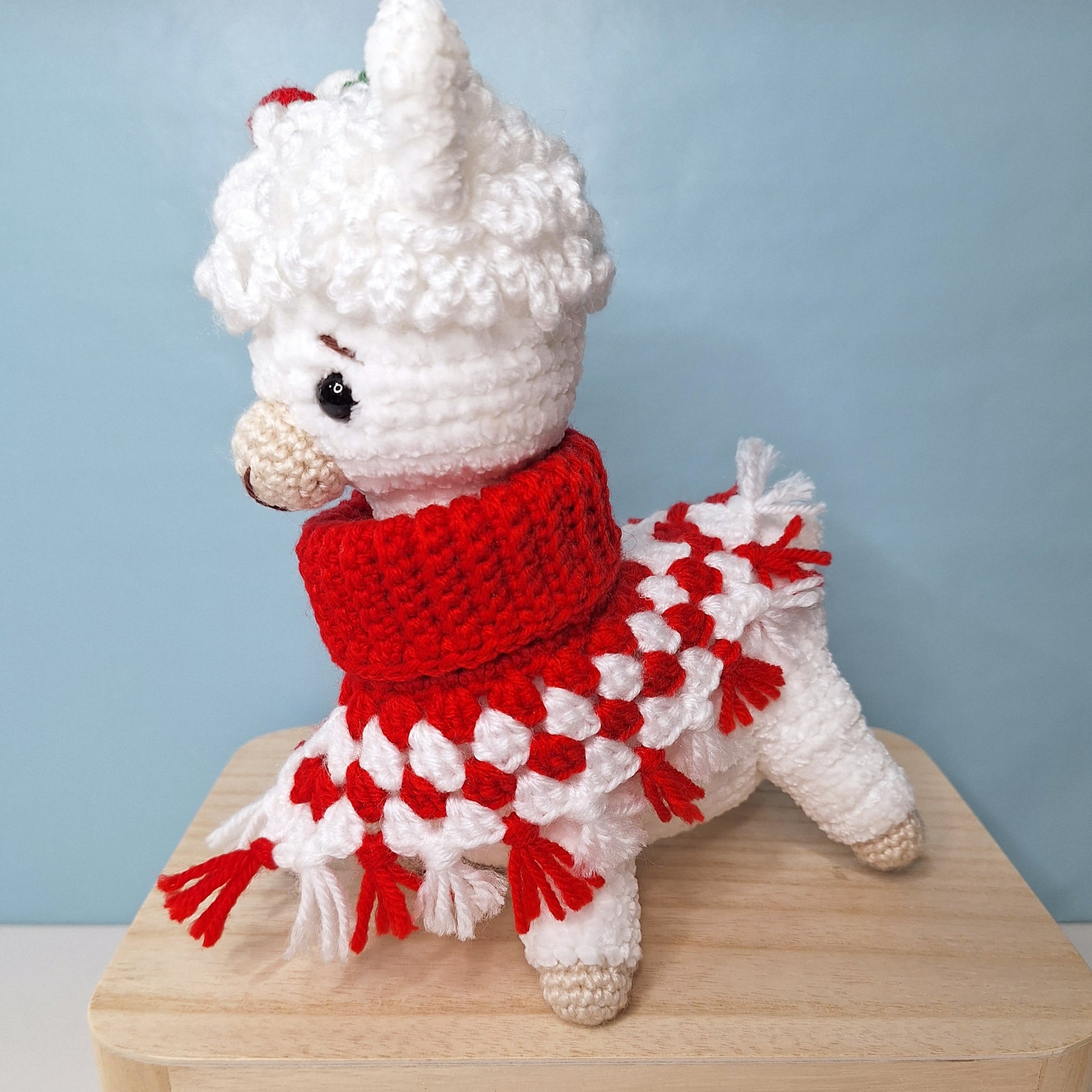 Crocheted Christmas Alpaca wearing a Poncho