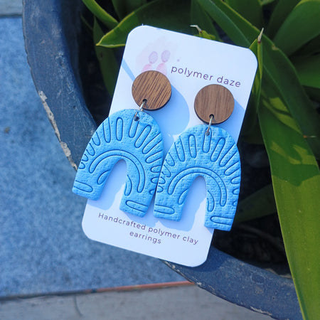 Embossed blue arch earrings with natural wood stud top