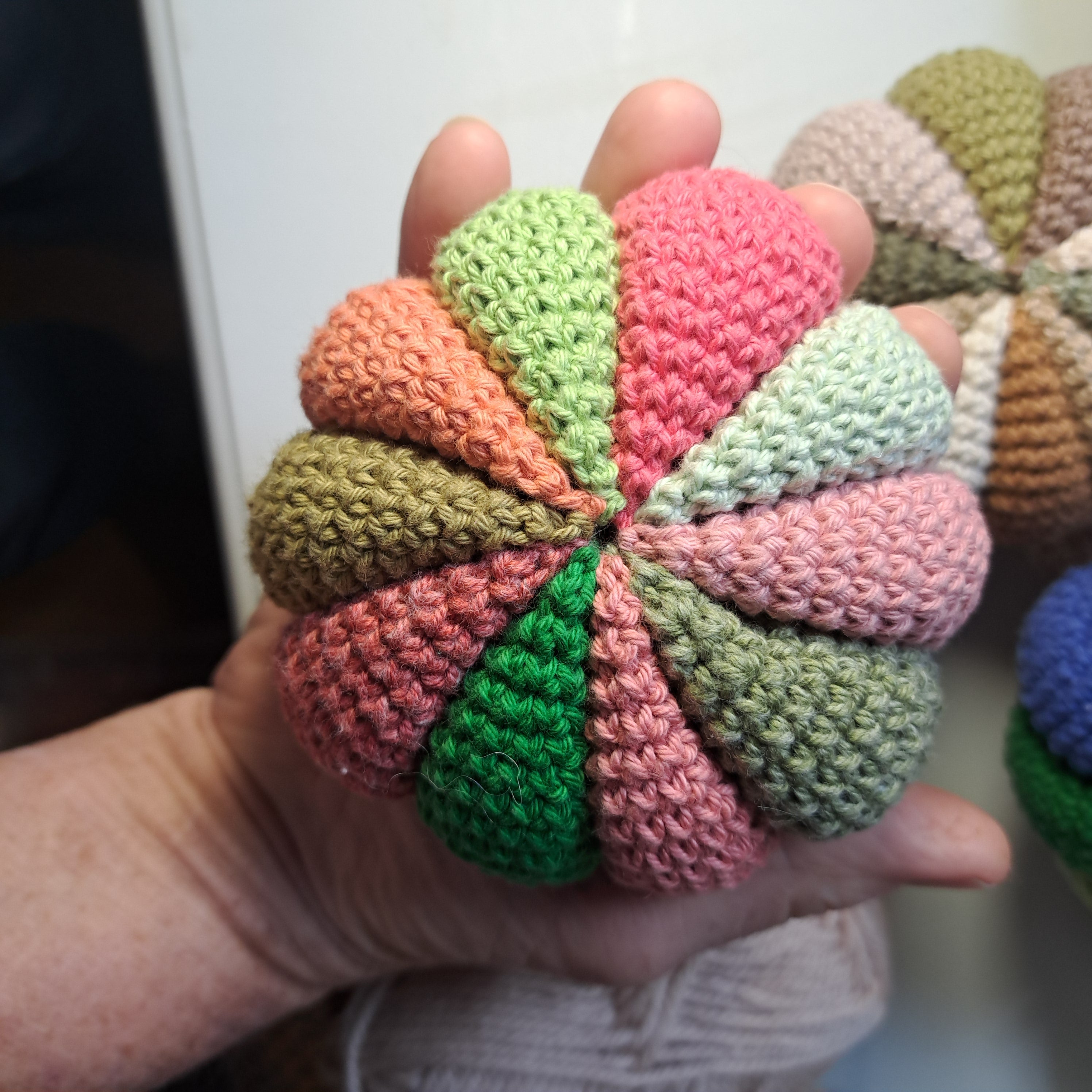 Crochet sensory ball/ with internal rattle/ pink and green colours