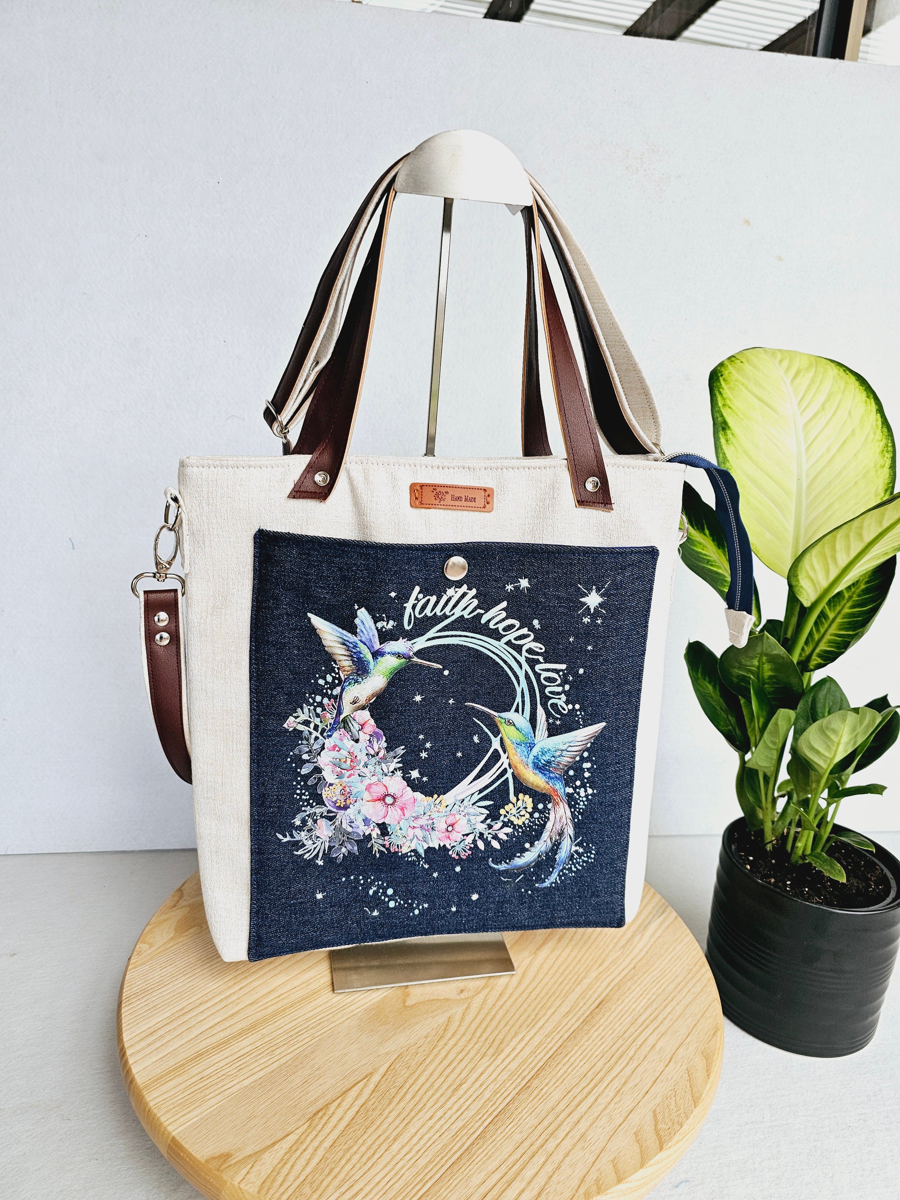 Modern hummingbird cross body bag featuring empowering words with ajustable strap