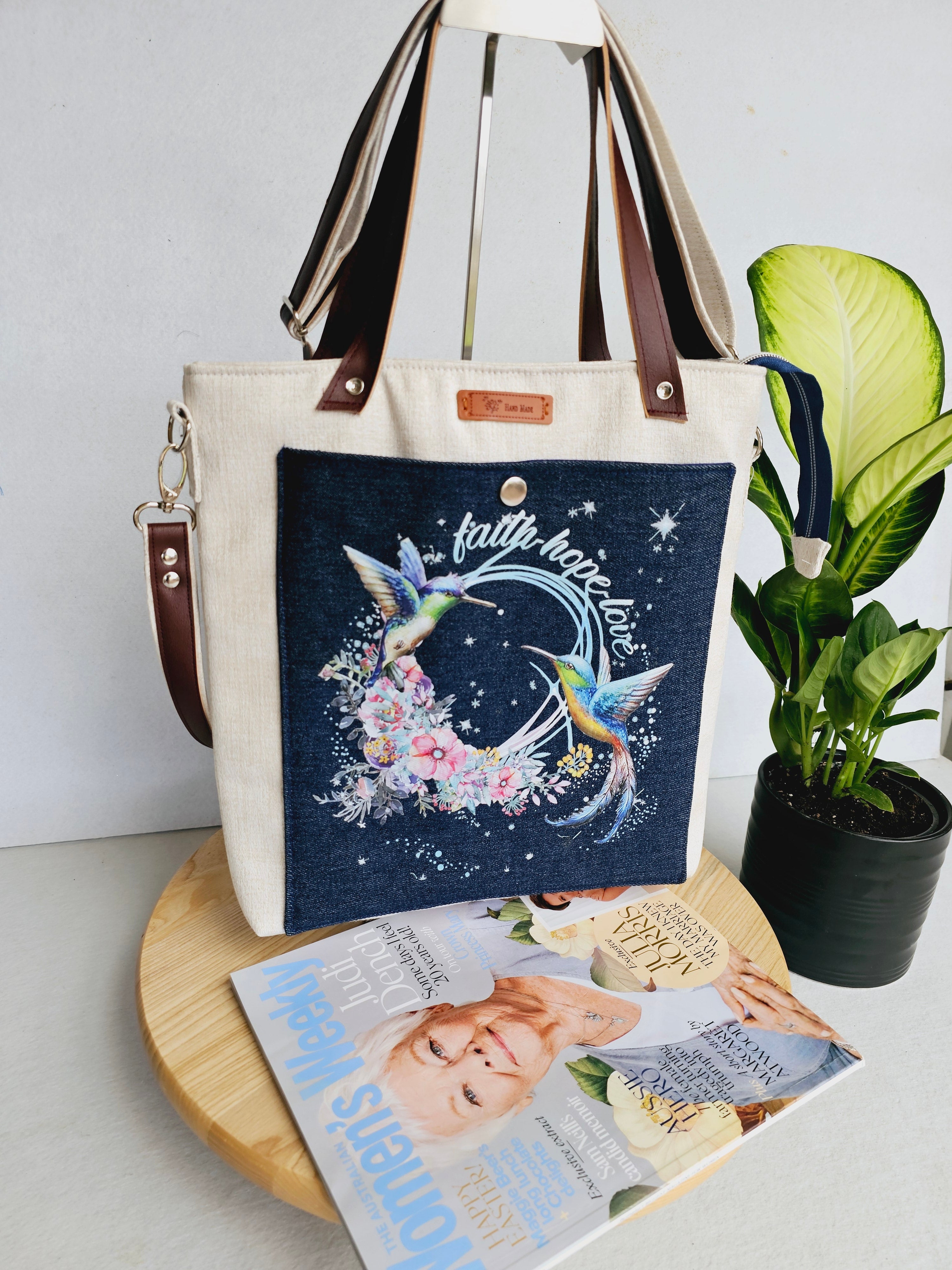 Modern hummingbird cross body bag featuring empowering words with ajustable strap