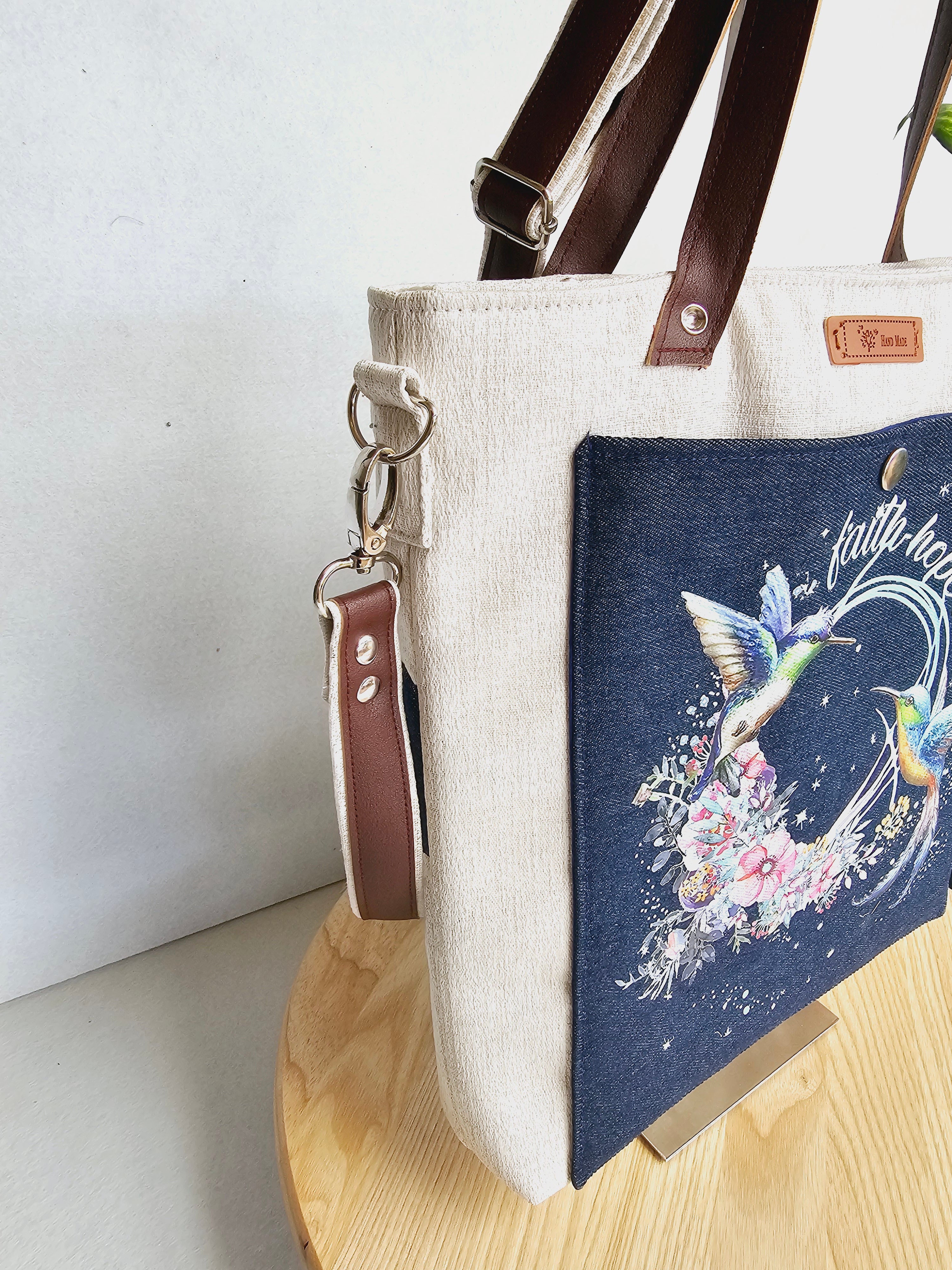 Modern hummingbird cross body bag featuring empowering words with ajustable strap