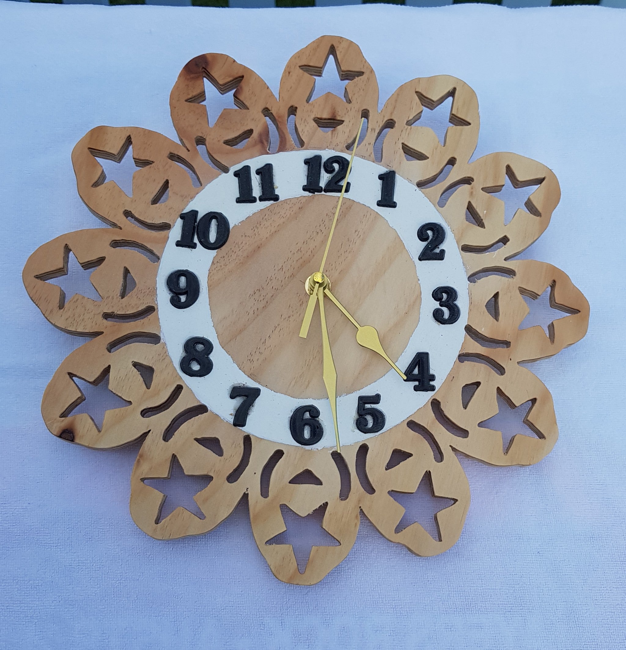 Clock 9: has a scroll sawn surround featuring 5 pointed stars.