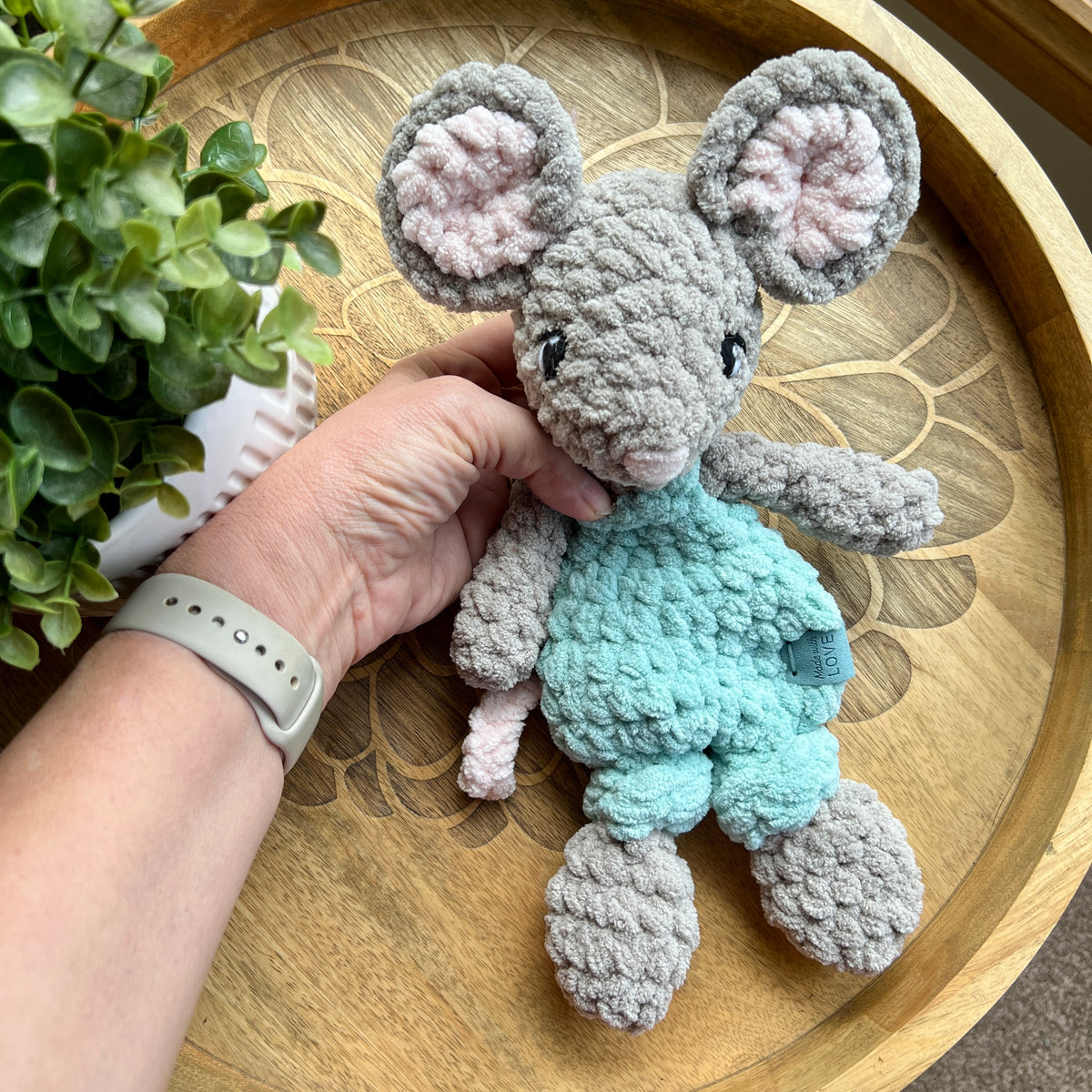 Handmade crochet Mini Mouse modern lovey in overalls with knotted legs.