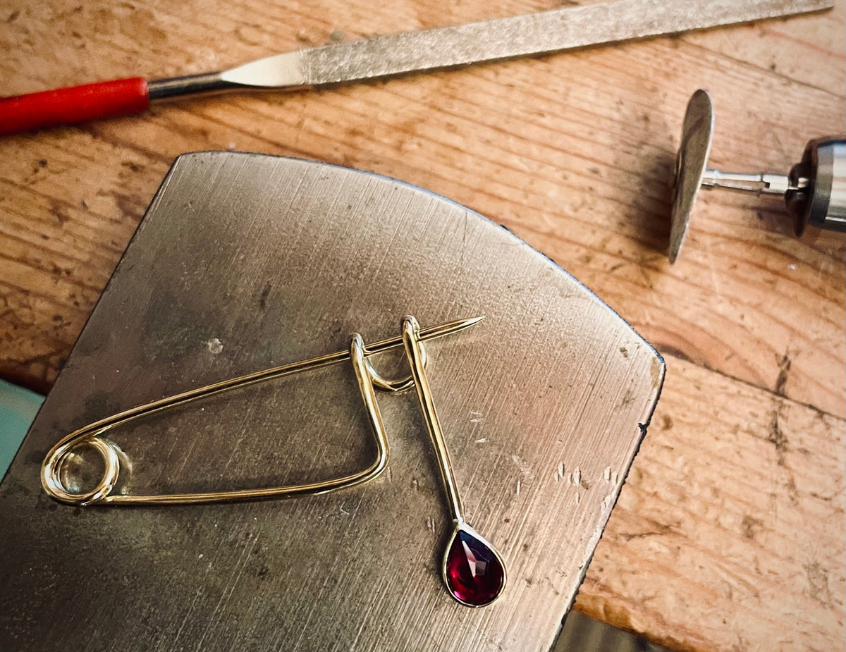 Brass and Ruby teardrop brooch