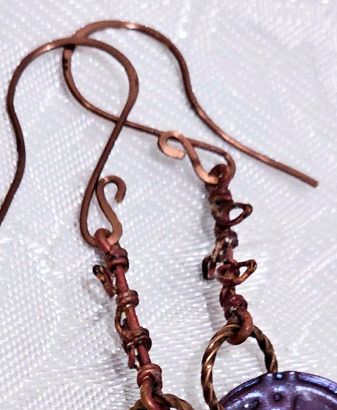 Suspended Pressed Metal Discs with Barbed Wirework Link and Black Matt Lampwork bead