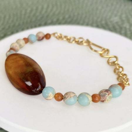 Boho beaded bracelet | Toffee and sky blue on gold | Vintage bead