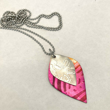 Printed and dyed anodised aluminium with textured flower motif pendant